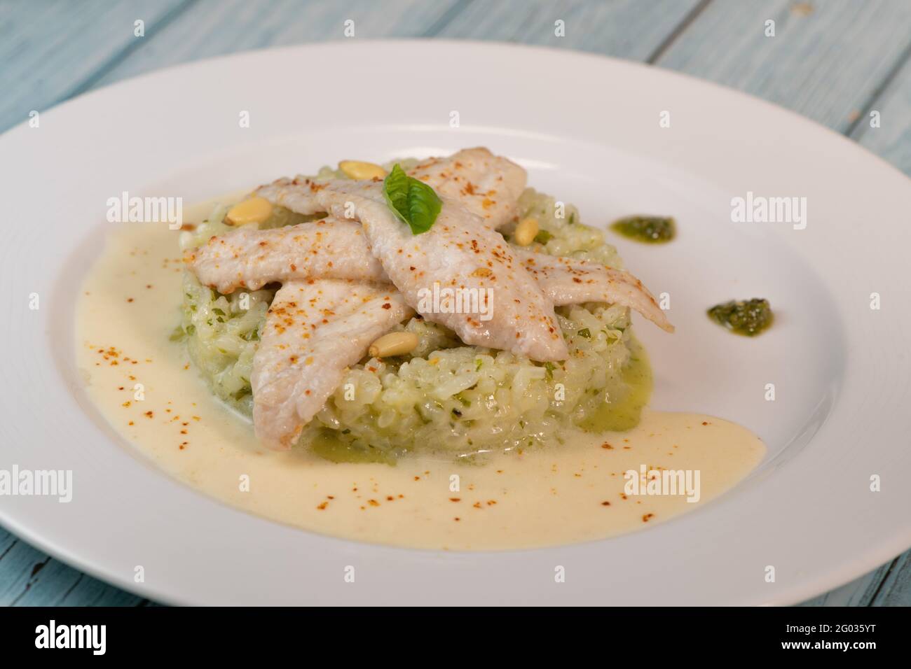 Baked sole fillet, risotto and pesto recipe Stock Photo