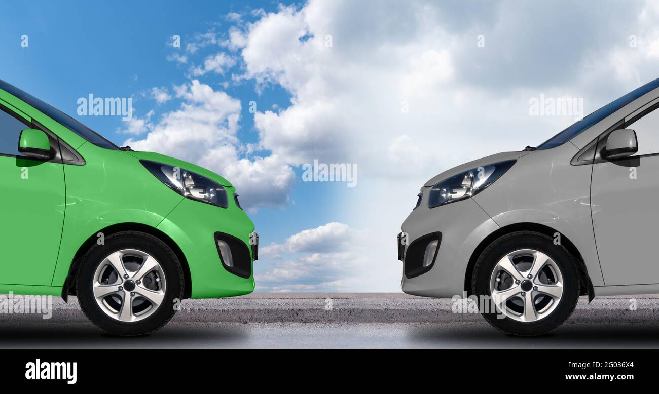 A green electric car in front of a gray petrol car. Clean transportation concept Stock Photo