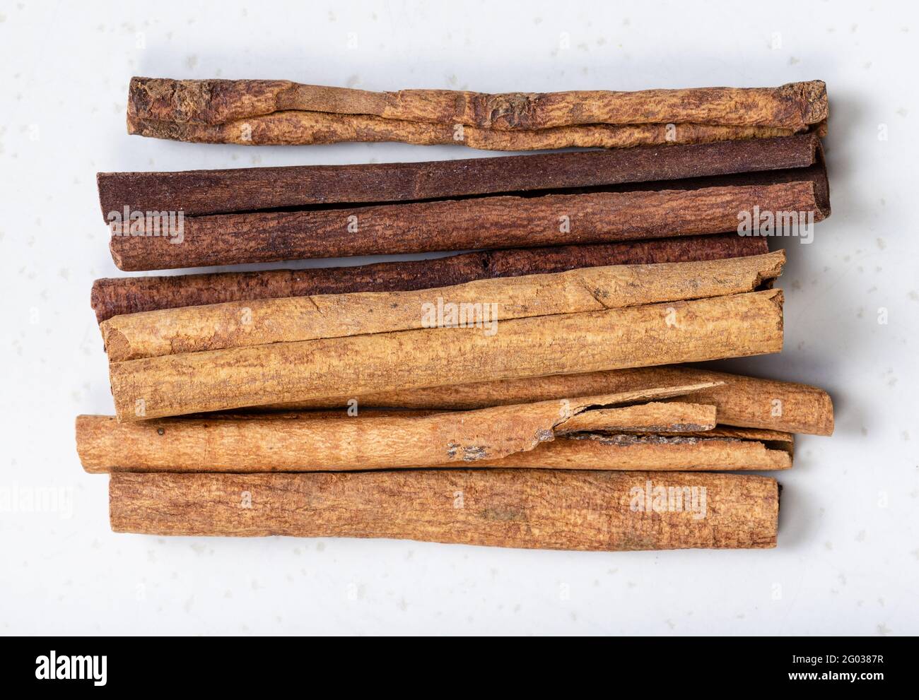 top view of cassia (chinese cinnamon) sticks close up on gray ceramic plate Stock Photo