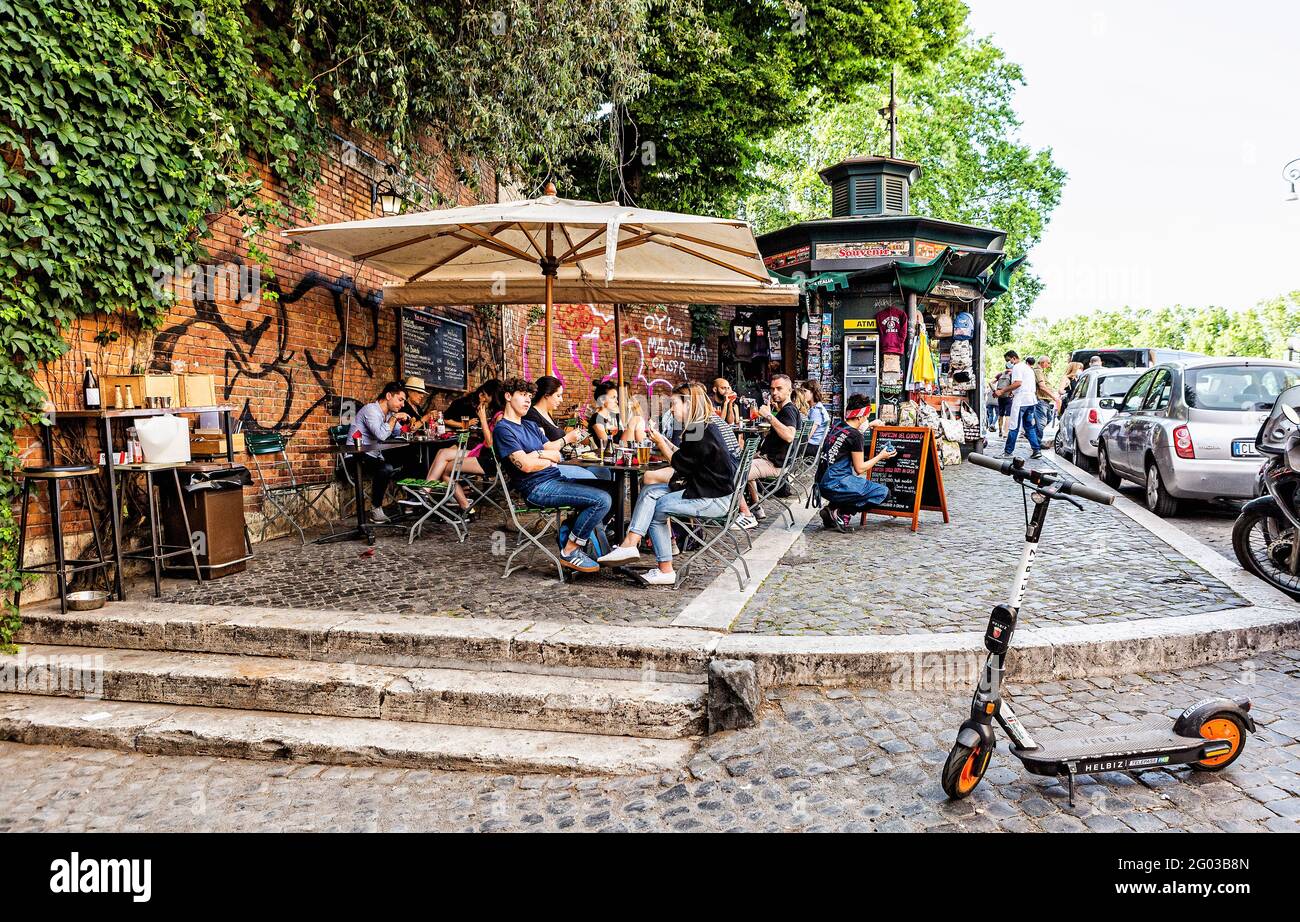 Young adults drinking at a pavement café in Rome Stock Photo