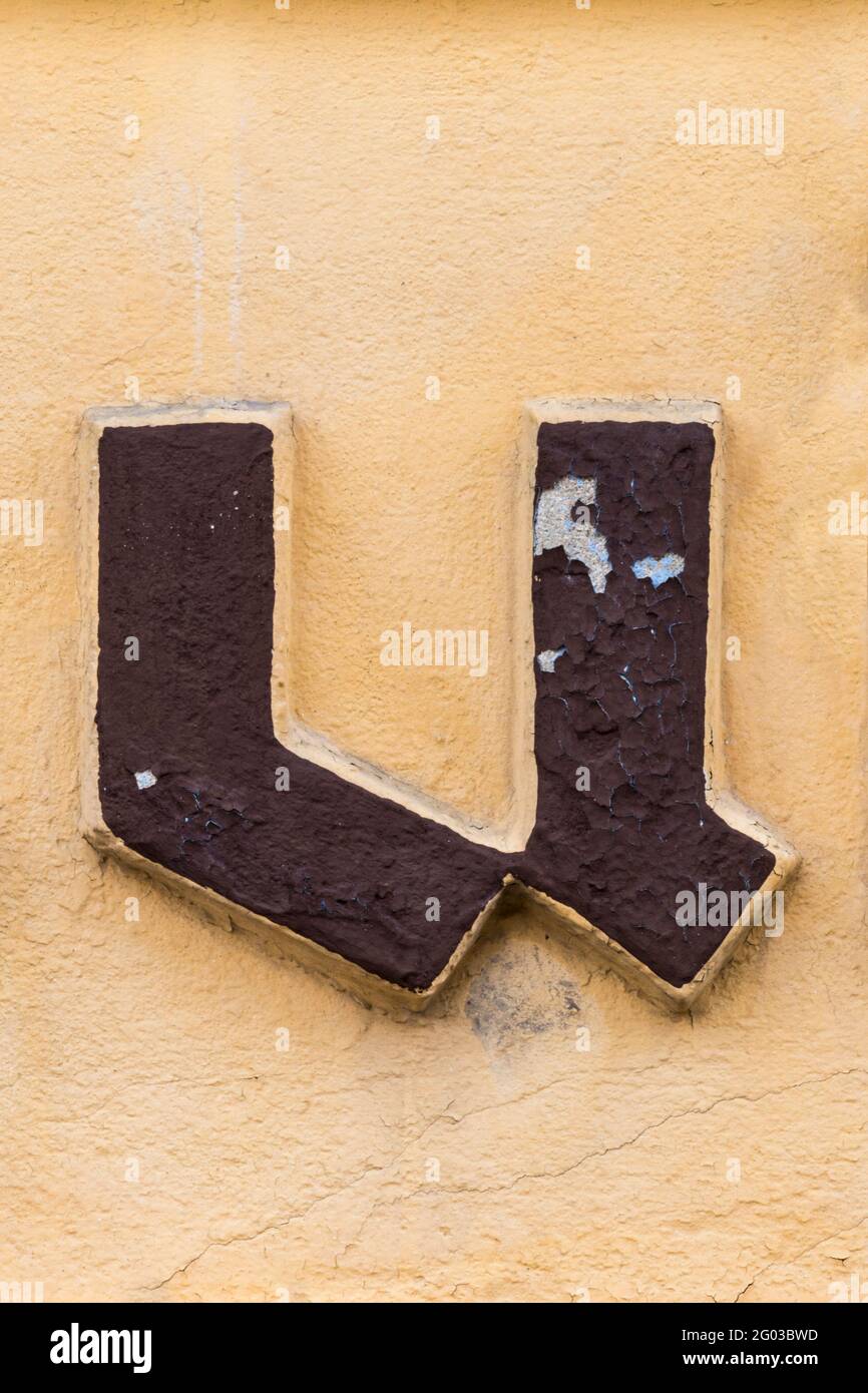 Brown black letter u on ochre yellow background Stock Photo