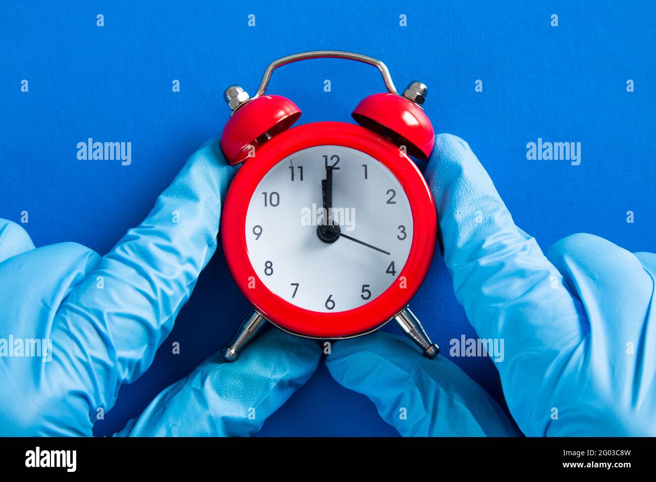 Medical doctor hand with an alarm clock. Health care concept Stock