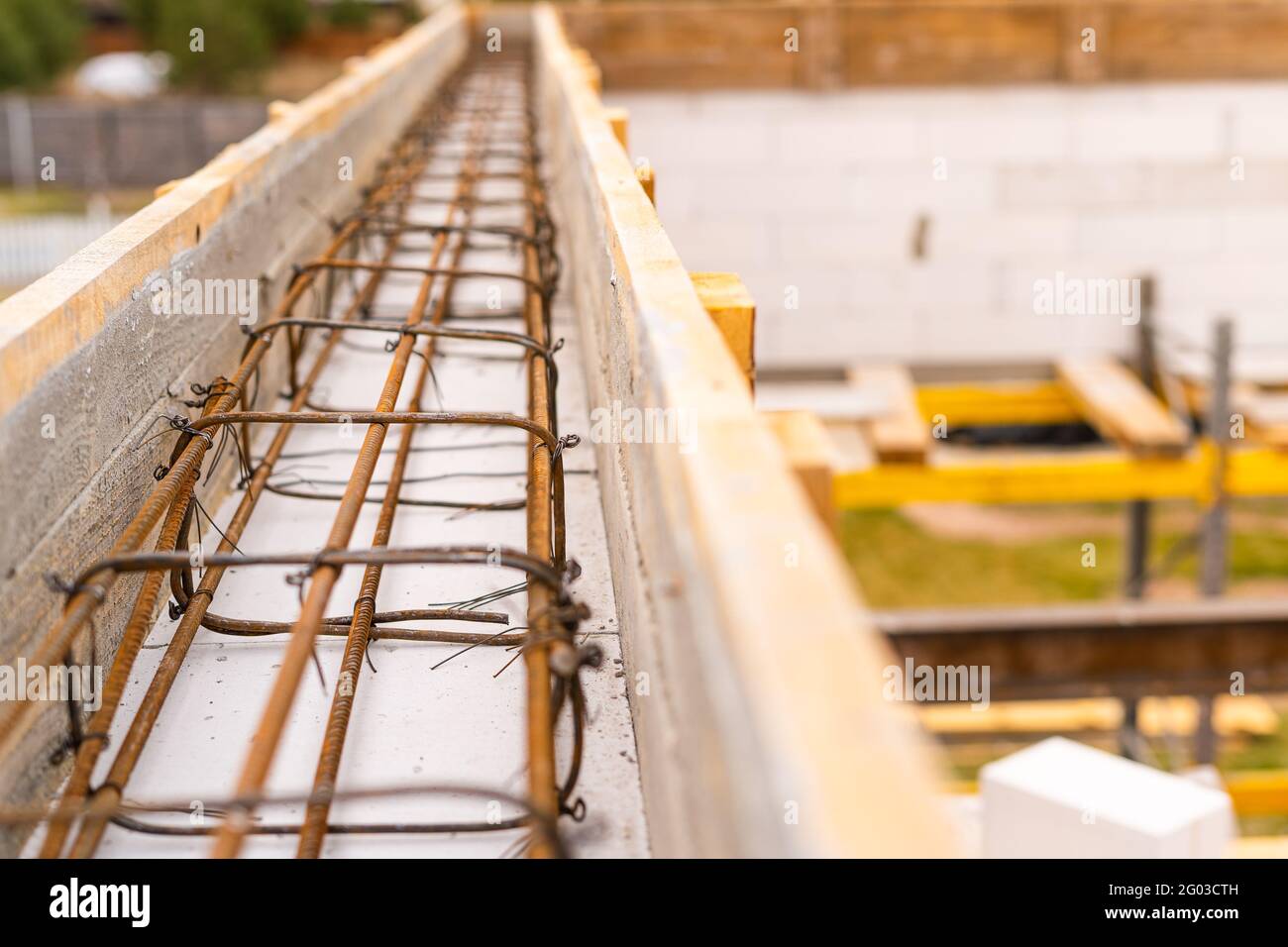 Reinforced belt in wooden formwork at a construction site close up