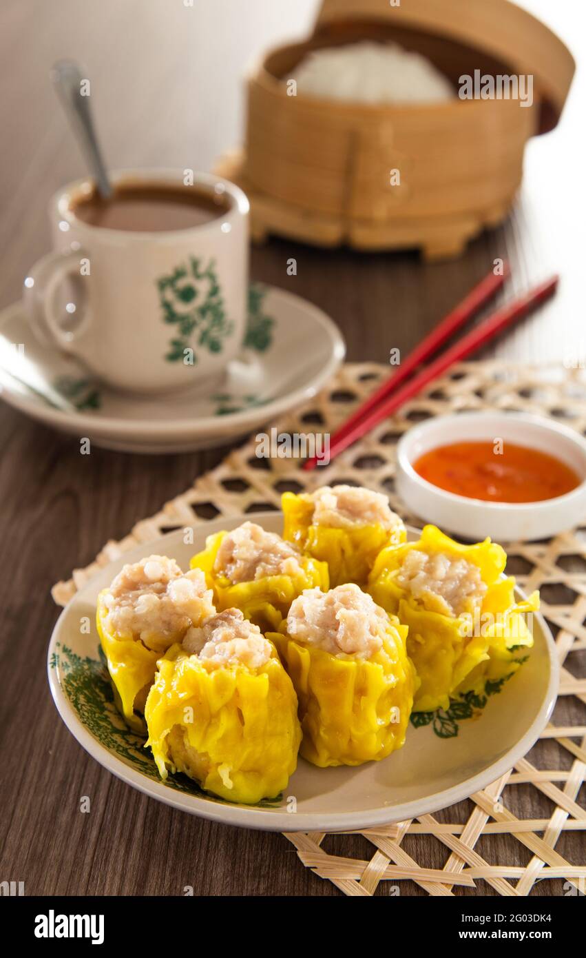 Siu Mai Chinese steamed pork dumplings in bamboo steamers Stock Photo