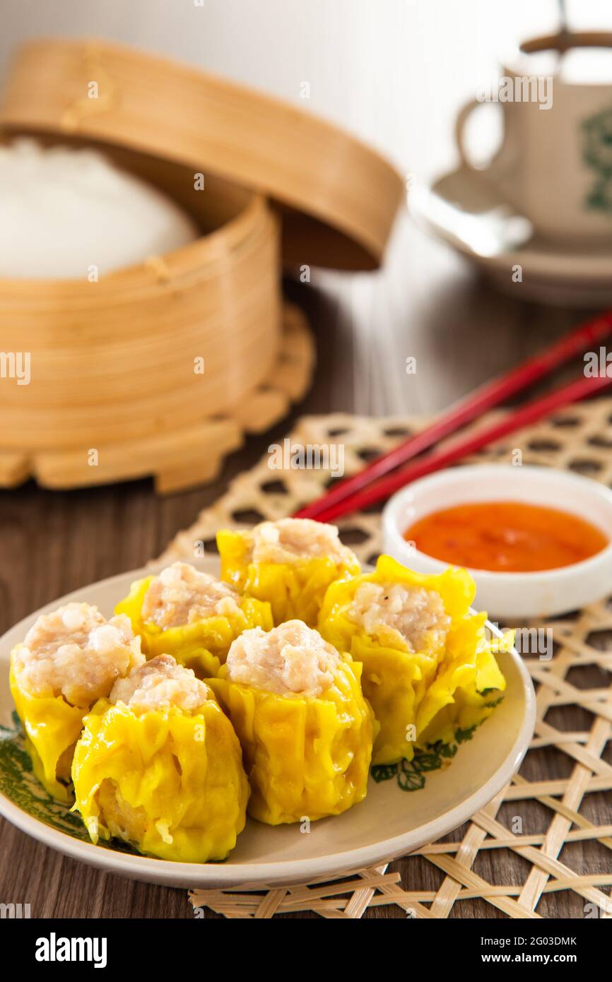 Siu Mai Chinese steamed pork dumplings in bamboo steamers Stock Photo