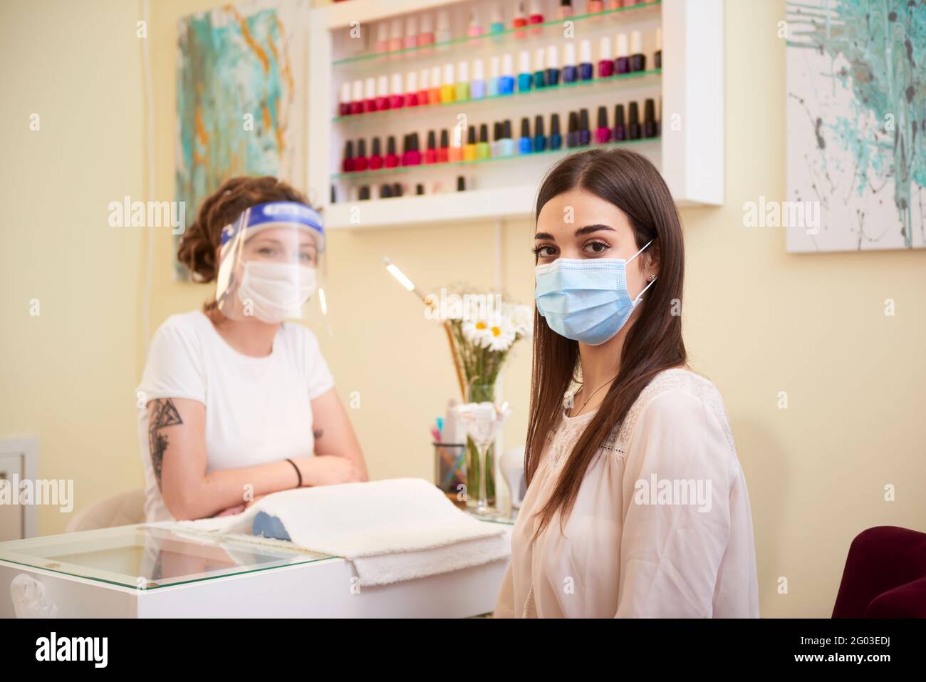 A person and a beautician at the beauty salon both looking at camera Stock Photo