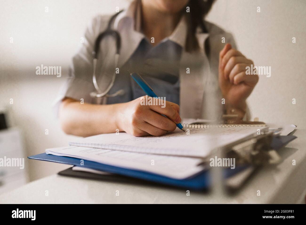 Midsection of female healthcare worker writing prescription Stock Photo