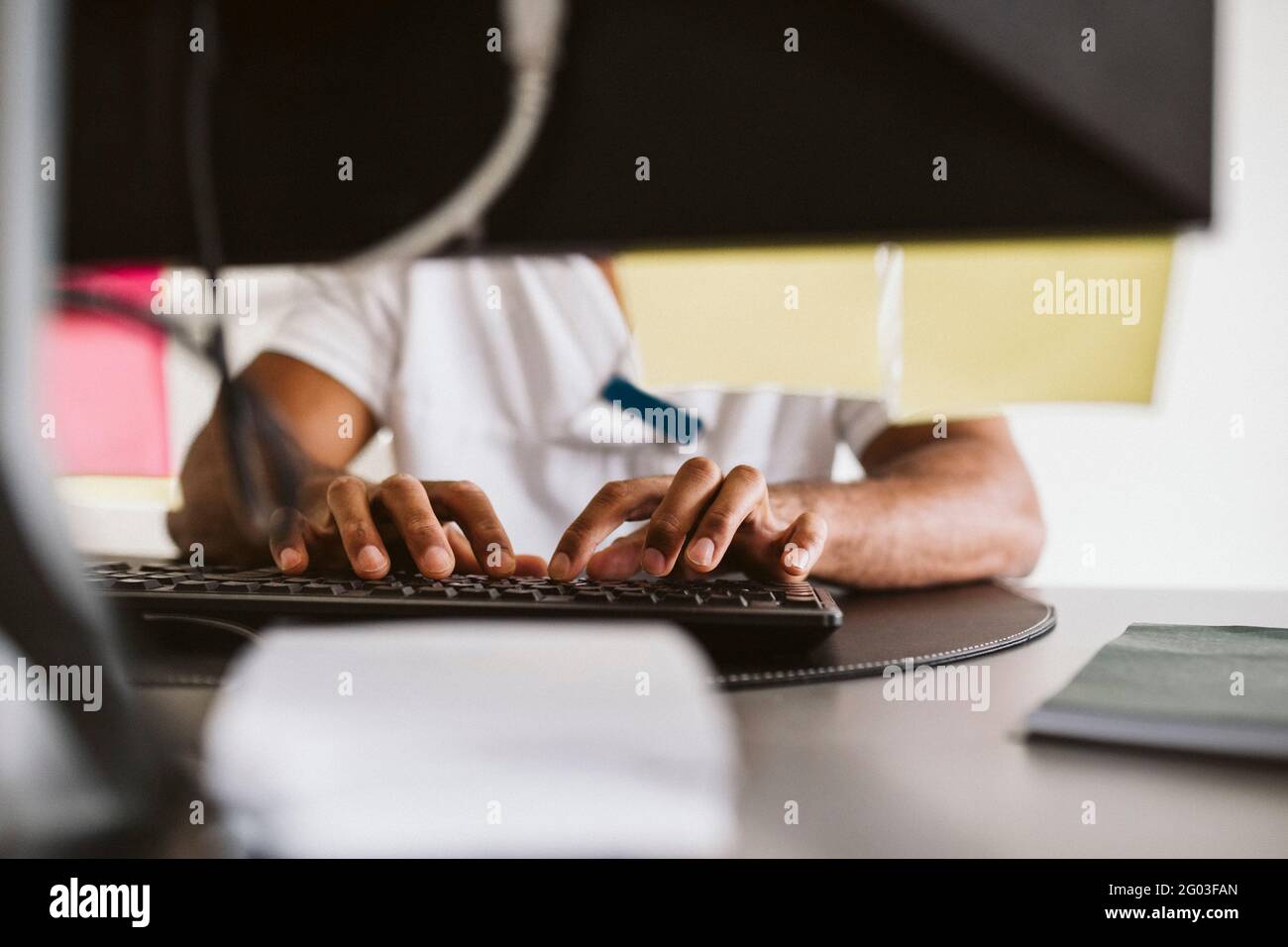 Midsection of male doctor typing while working at medical clinic Stock Photo