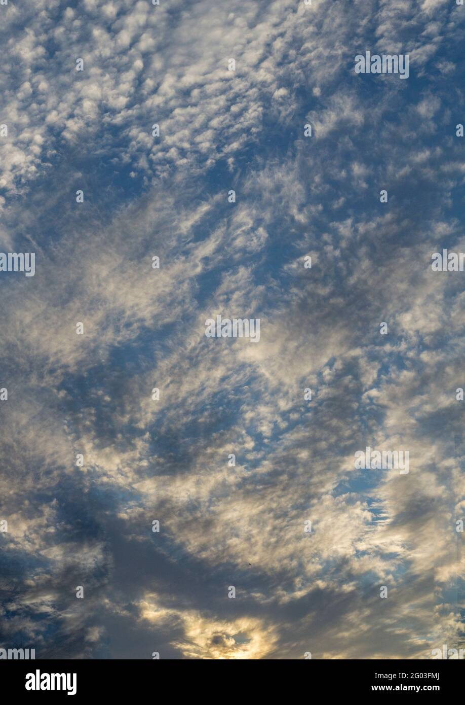 Dramatic clouds against blue sky. Vertical view Stock Photo