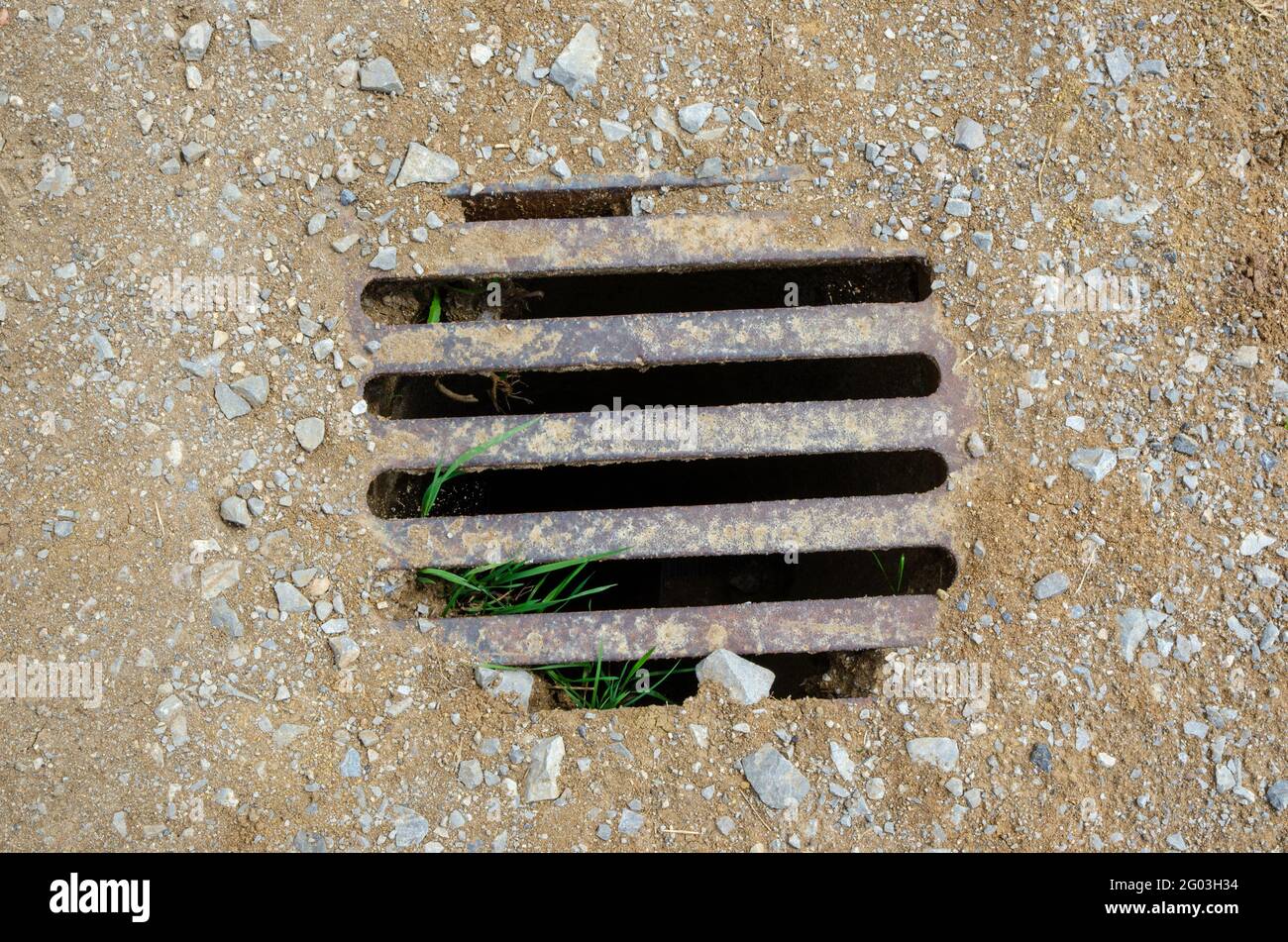 Channel grid surrounded by sand and gravel. Stock Photo