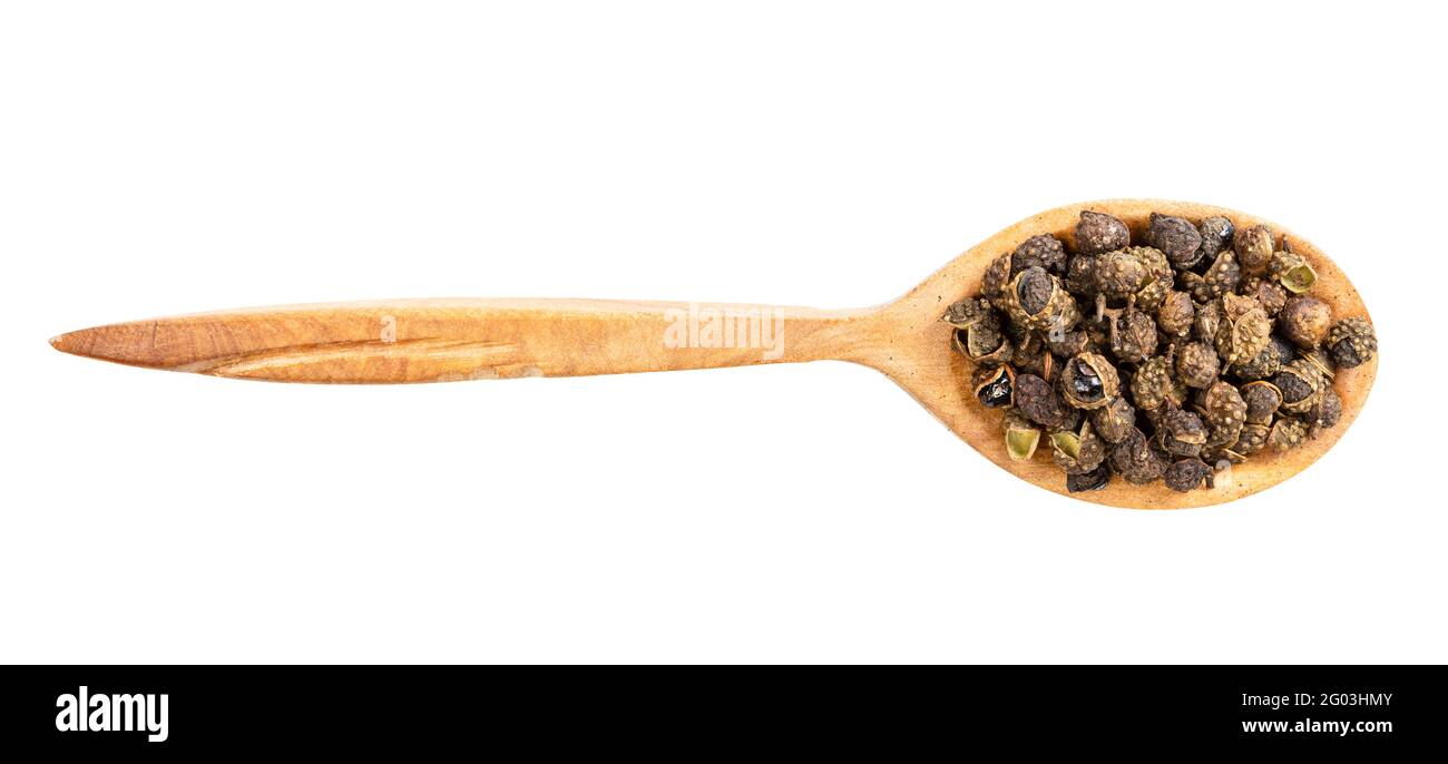 top view of wood spoon with sichuan pepper peppercorns isolated on white background Stock Photo