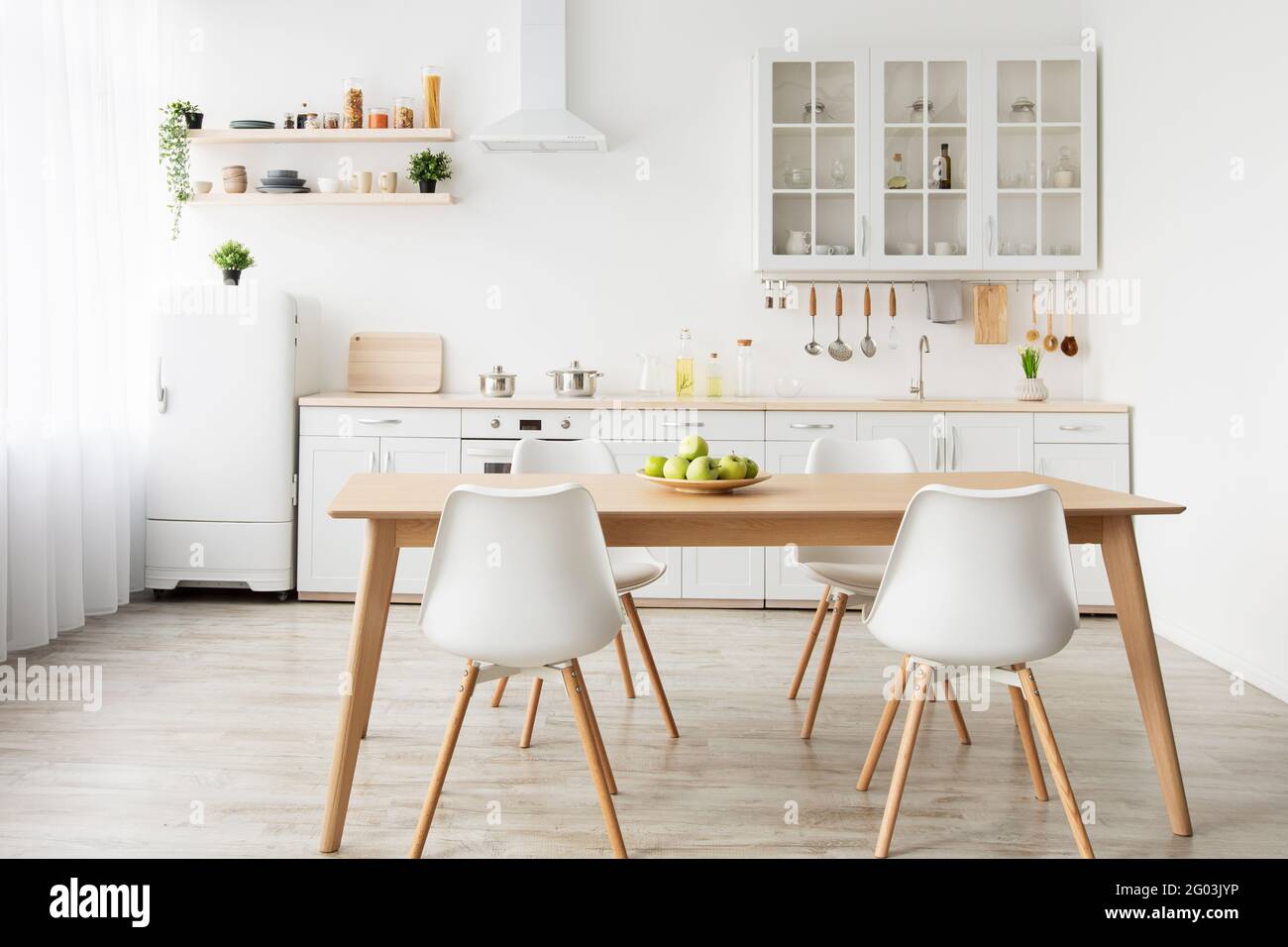 Dining room and stylish design. Wooden table and white chairs, kitchen