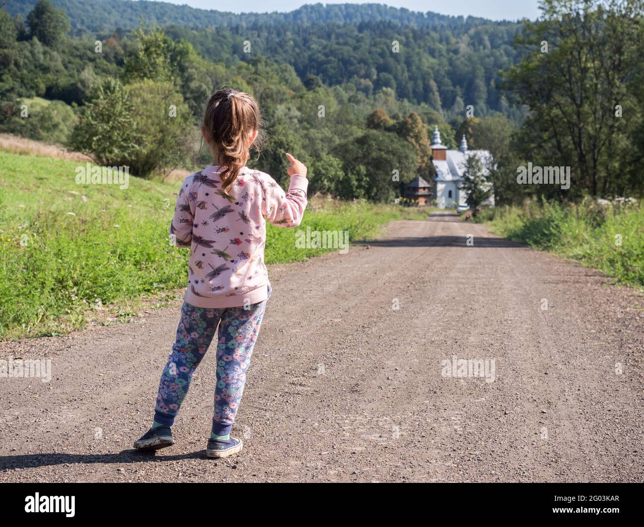 Łopienka, Poland-August 2018: Small girl on the trail to the Greek Catholic Church in Łopienka, Bieszczady, Europe Stock Photo