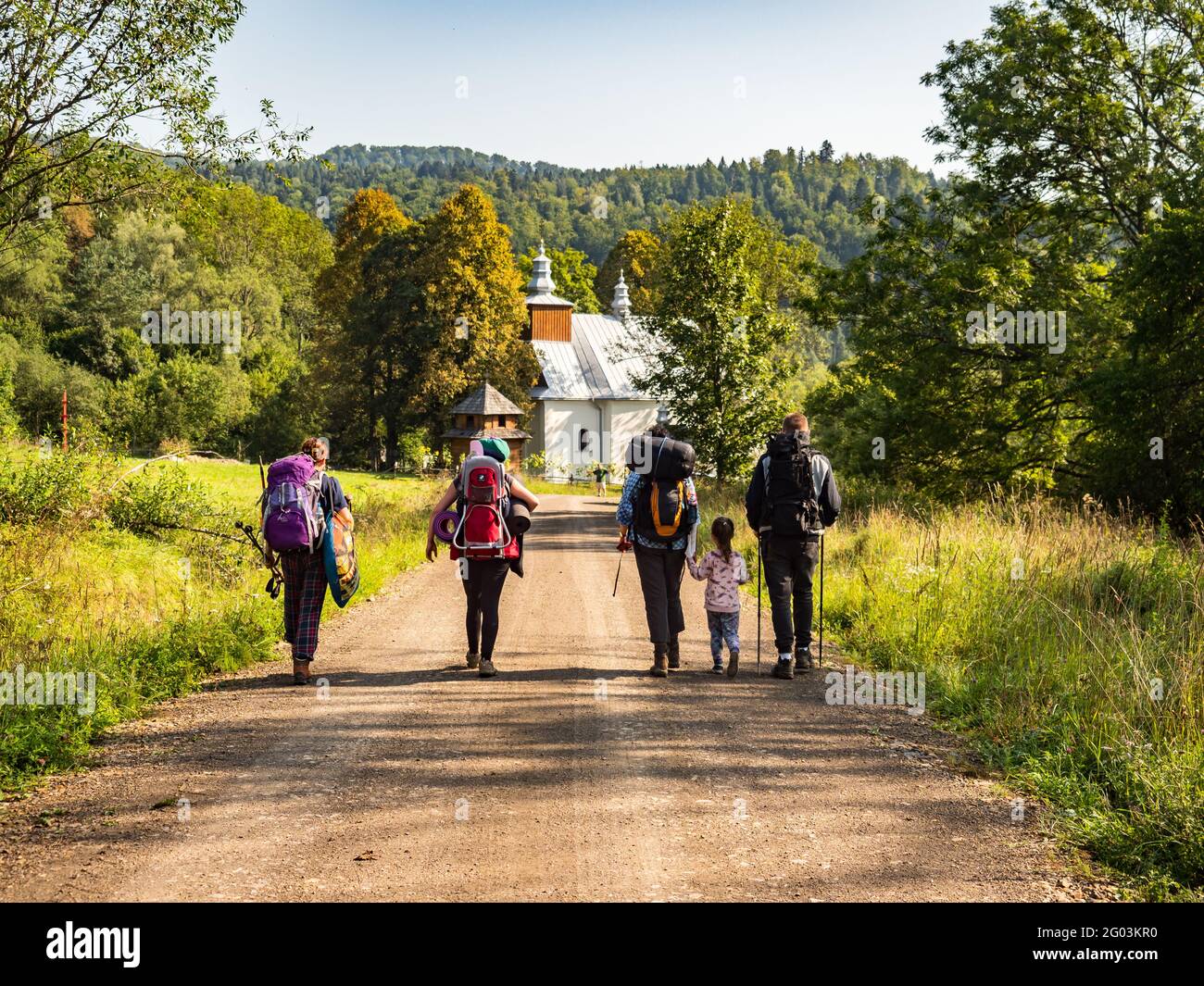 Łopienka, Poland-August 2018: Tourists with backpacks on the trail to the Greek Catholic Church in Łopienka, Bieszczady, Europe Stock Photo
