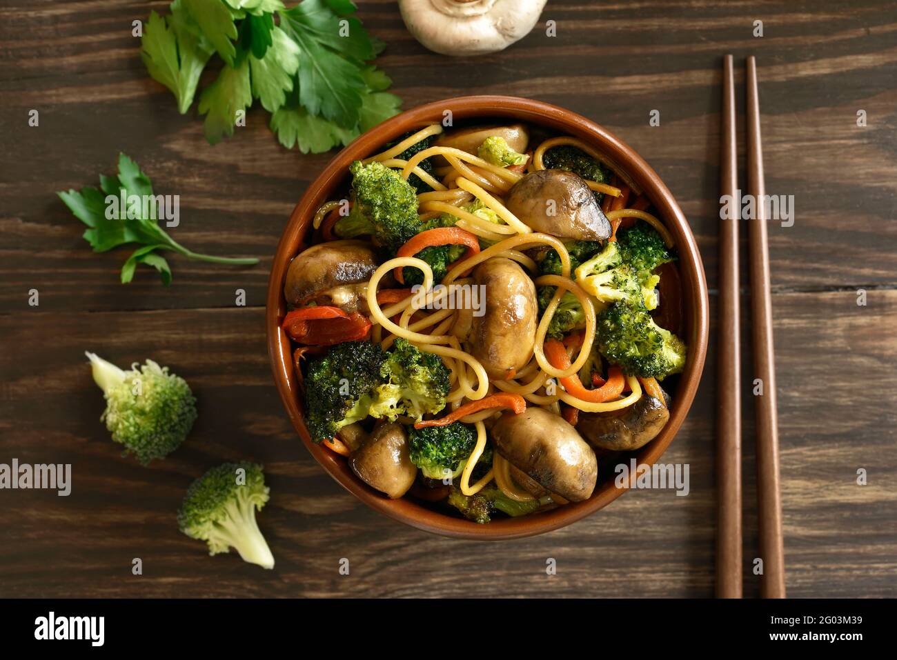 Egg noodles with vegetables in bowl on wooden table. Top view, flat lay Stock Photo