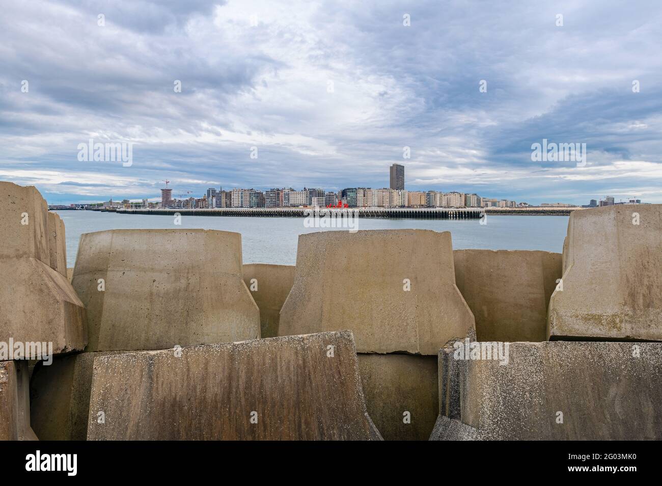 Ostend (Oostende) cityscape with giant concrete blocks of the breakwater, West Flanders, Belgium. Stock Photo