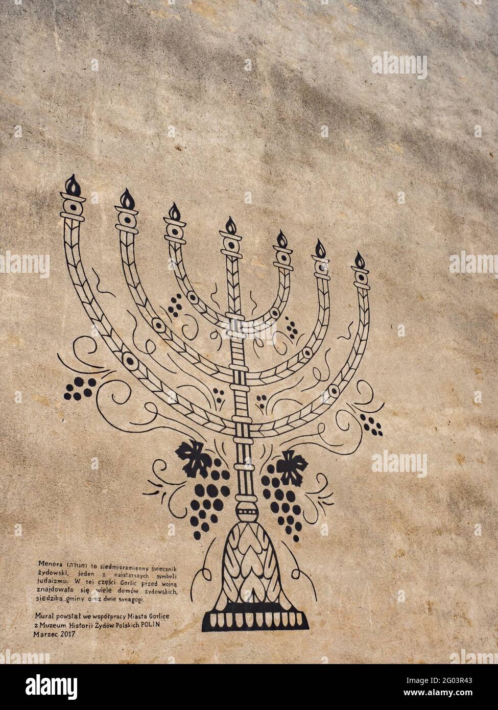 Gorlice, Poland-Aug 2018: Menorah is a seven-branched Jewish candlestick, one of the oldest symbols of Judaism. Mural on the wall of a house in a dist Stock Photo