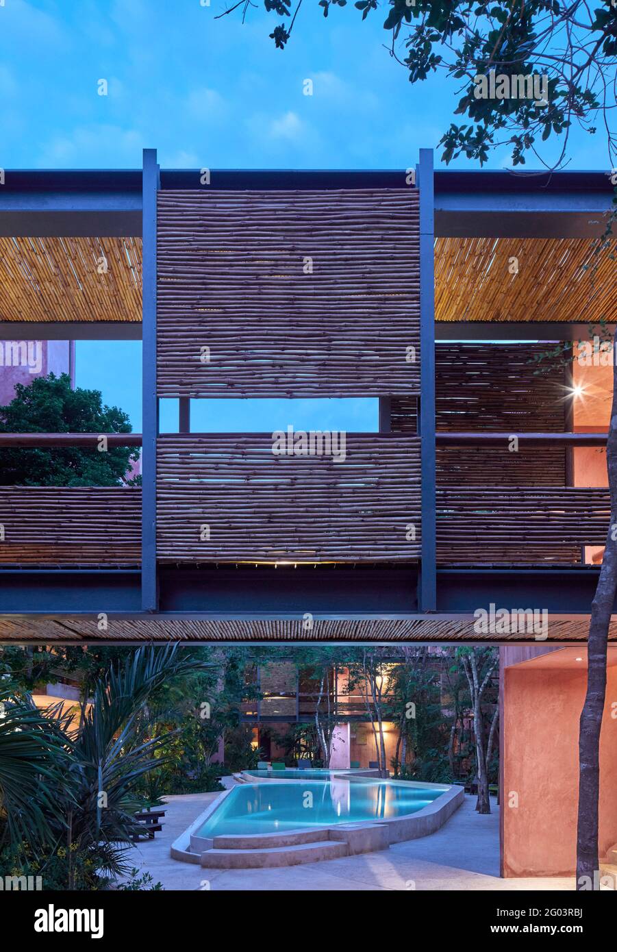 Twilight in communal pool area. Tulum Apartments, Tulum, Mexico. Architect Reyes Rios + Larrain