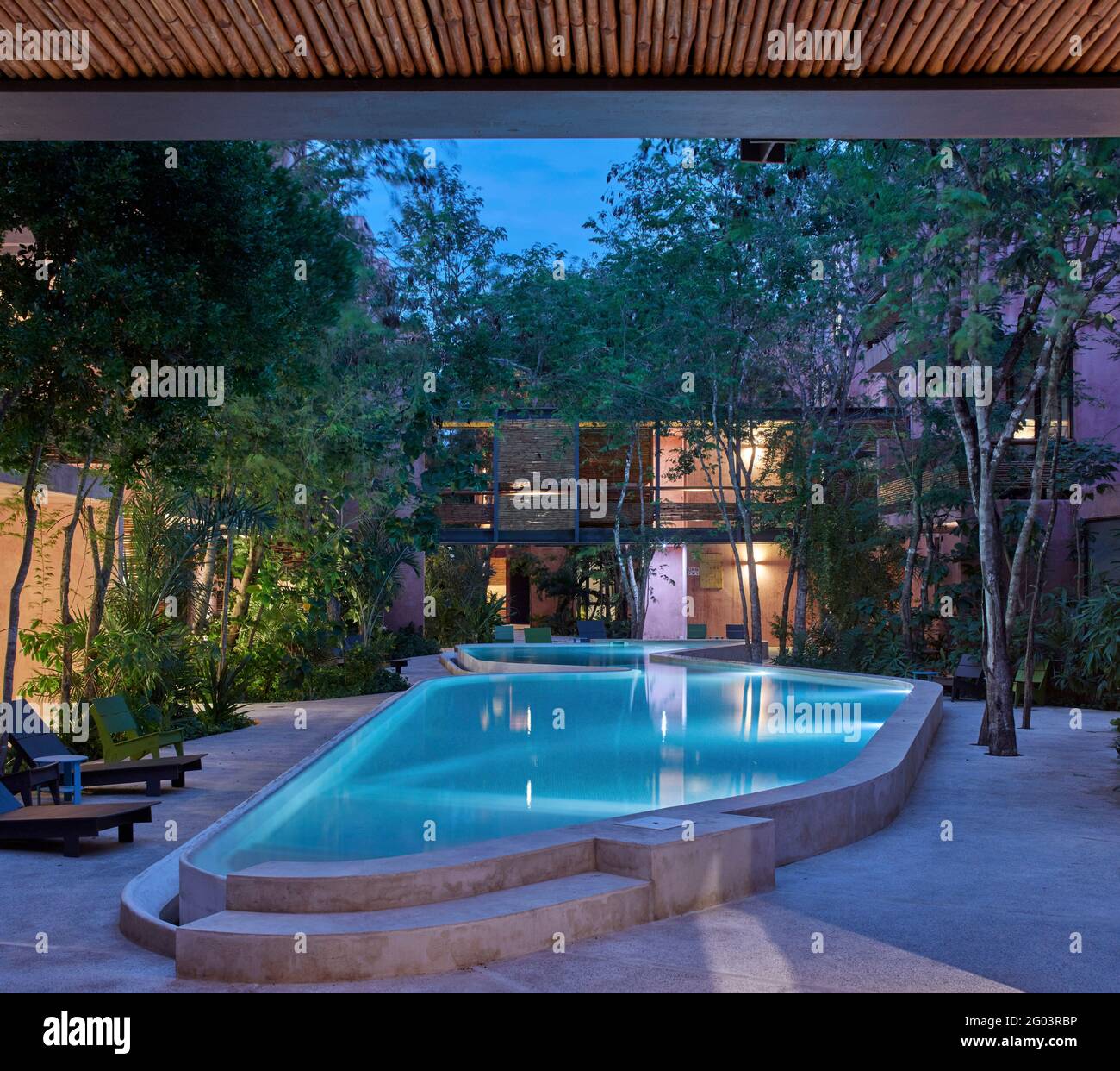 Twilight in communal pool area. Tulum Apartments, Tulum, Mexico. Architect Reyes Rios + Larrain