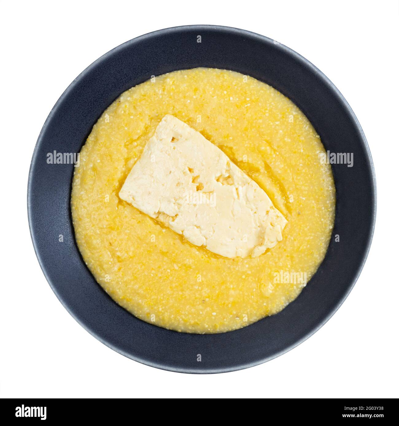 top view of cooked cornmeal porridge with piece of brined cheese in gray bowl isolated on white background Stock Photo