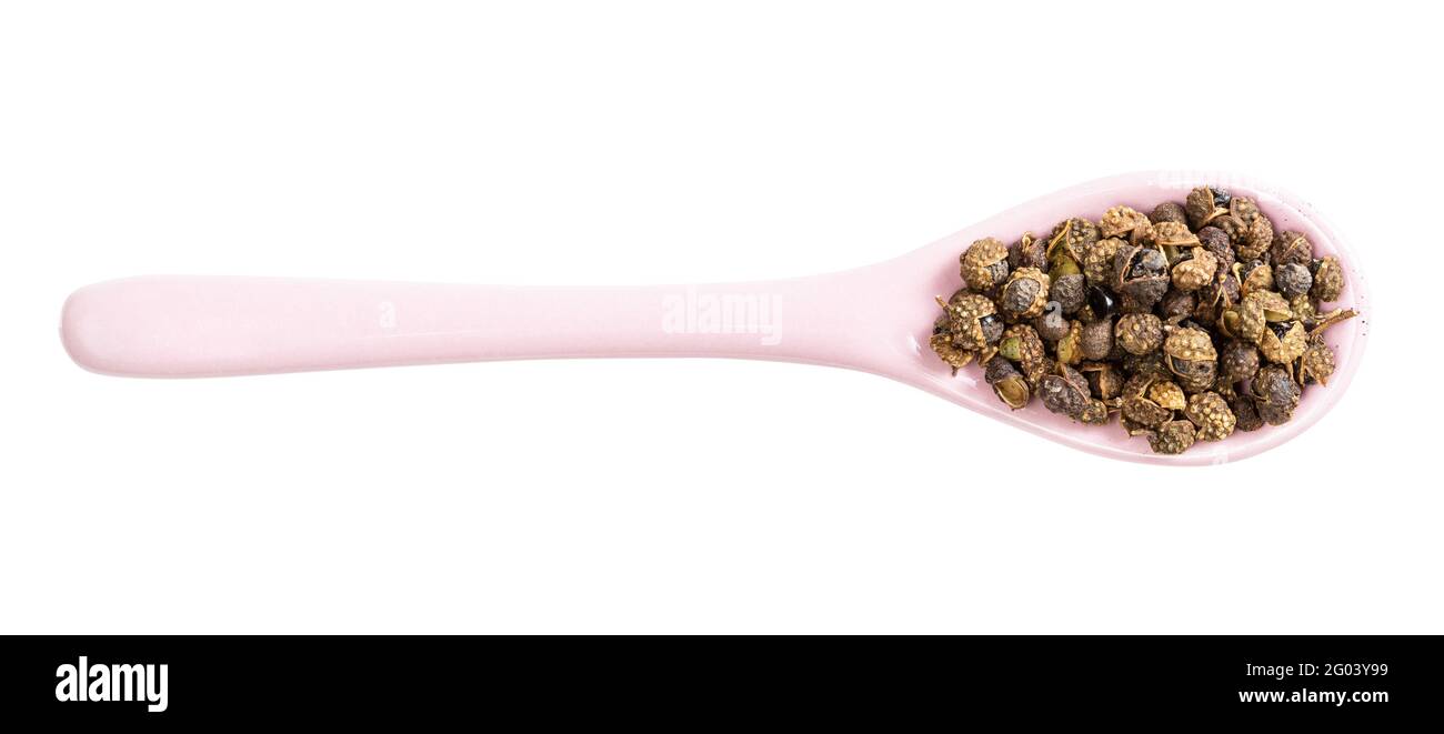 top view of ceramic spoon with sichuan pepper peppercorns isolated on white background Stock Photo