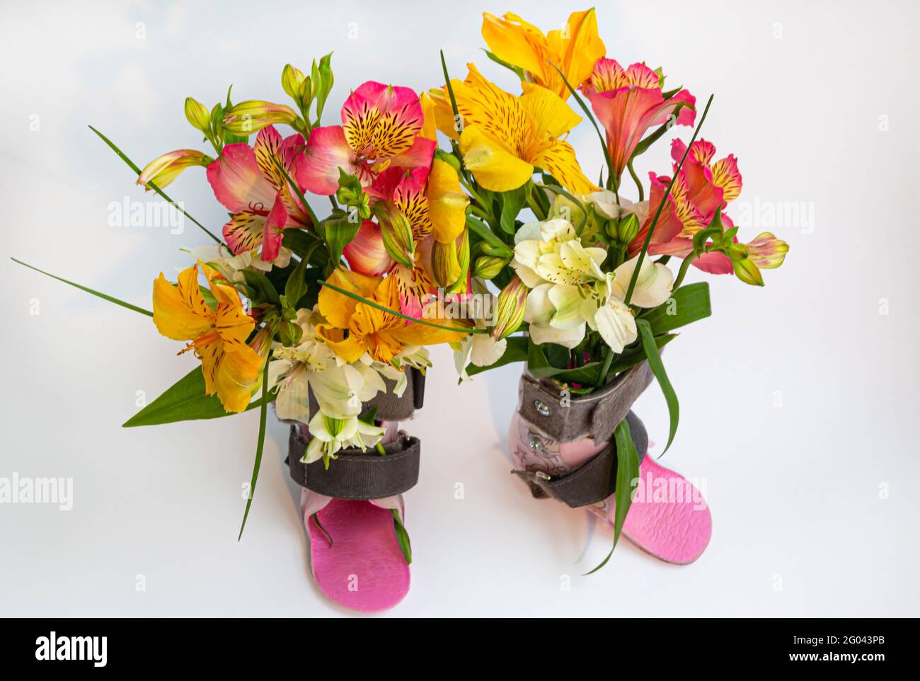 Photo from above. Two orthoses close up photo. A bouquet of flowers was inserted into the orthosis. I hope for recovery, rehabilitation of children. Stock Photo