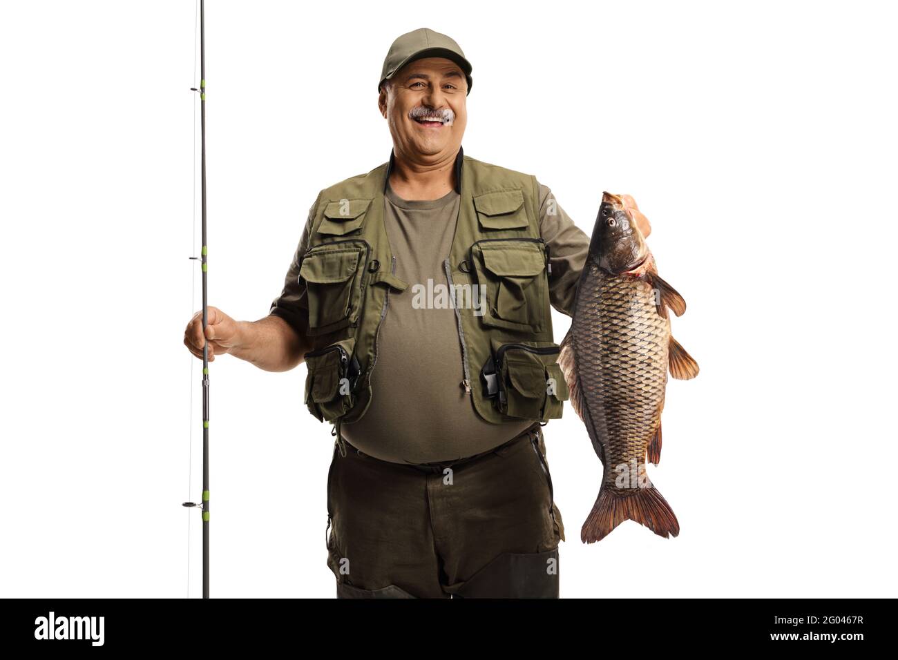 Smiling mature fisherman holding a fishing rod and a big carp fish isolated  on white background Stock Photo - Alamy