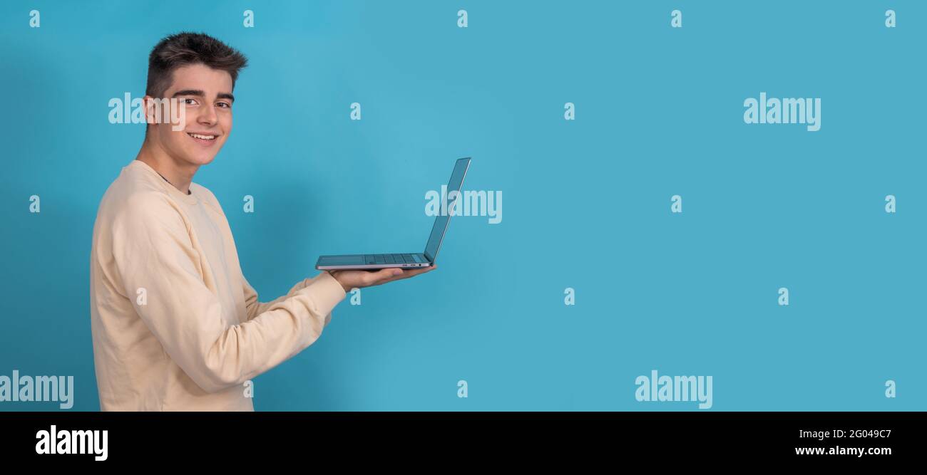 student teenager with laptop isolated from profile with space Stock