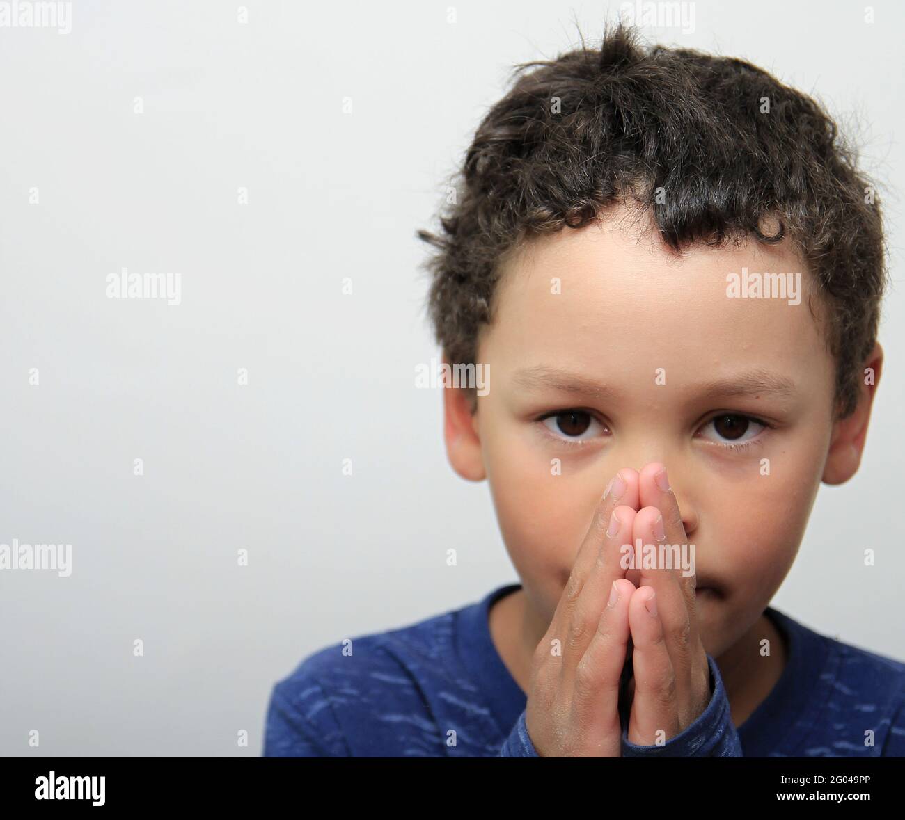 Little boy praying to god with hands together stock photo stock photo ...