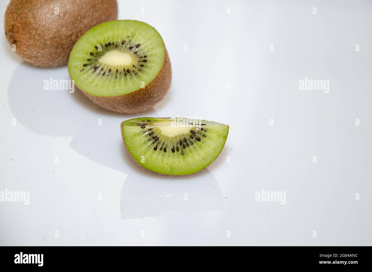Kiwi fruit cut into pieces cook white Stock Photo Alamy