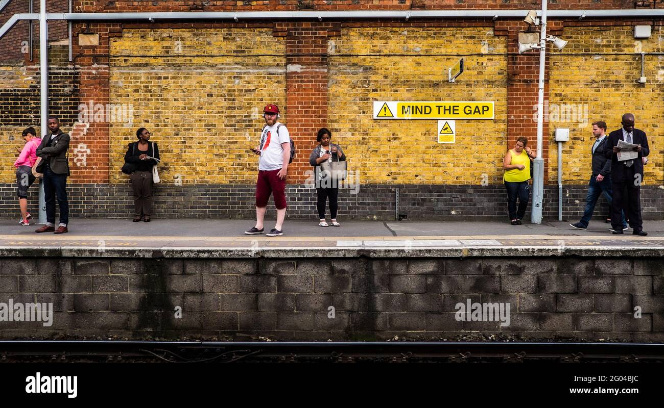 London, UK; May 9th 2018: People waiting at train station. Stock Photo