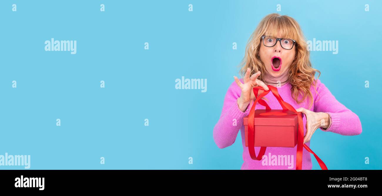 woman opening gift box with surprise Stock Photo