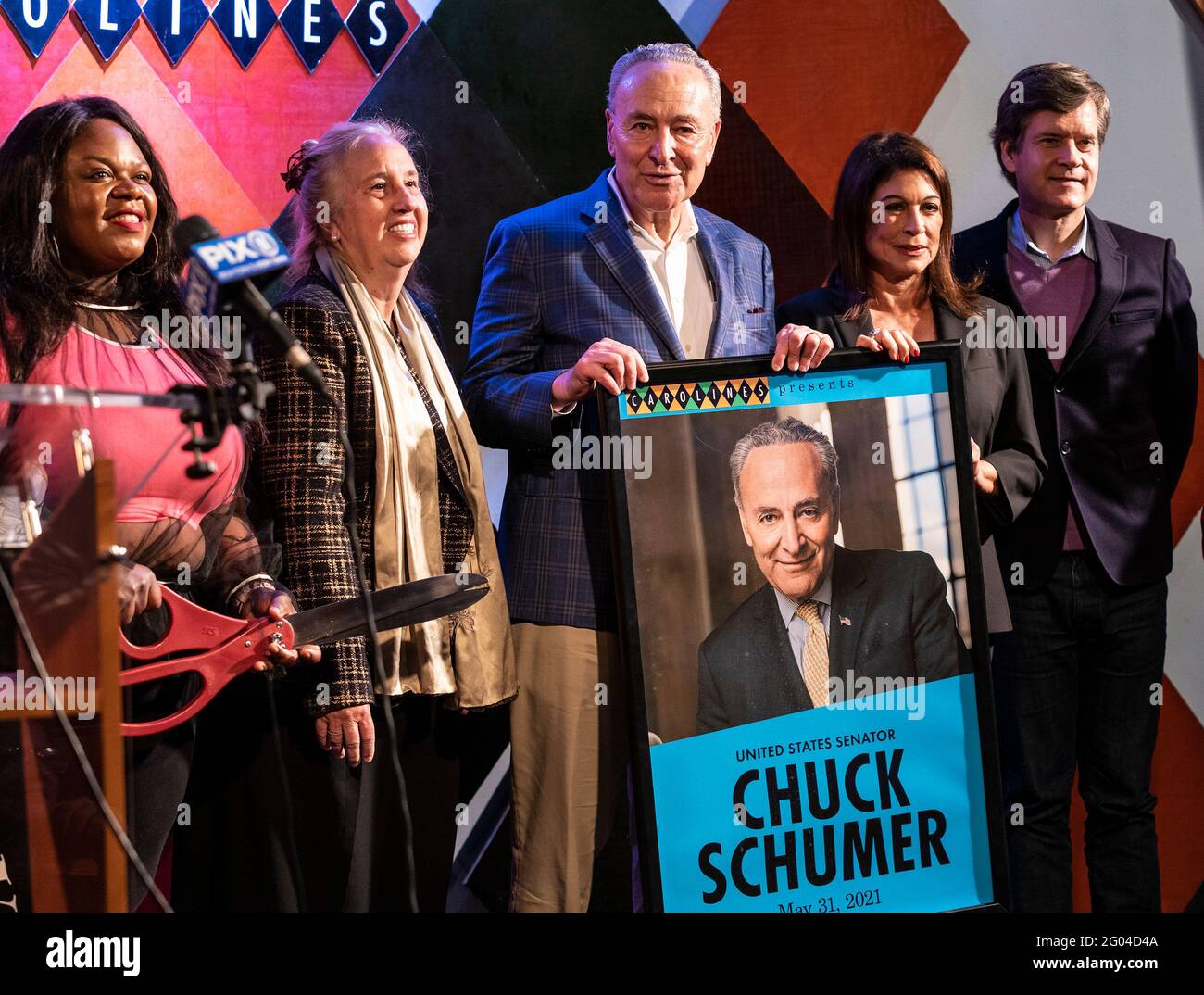 New York, United States. 31st May, 2021. U. S. Senator Charles Schumer holds poster presented to him at Carolines on Broadway comedy club re-opening after pandemic ceremony. Senator Charles Schumer lauded Safe our Stages (SOS) bill passed by Senate to help cultural venues to survive pandemic. He also cracked few jokes saying it is comedy club he does not have a choice but say them. (Photo by Lev Radin/Pacific Press) Credit: Pacific Press Media Production Corp./Alamy Live News Stock Photo