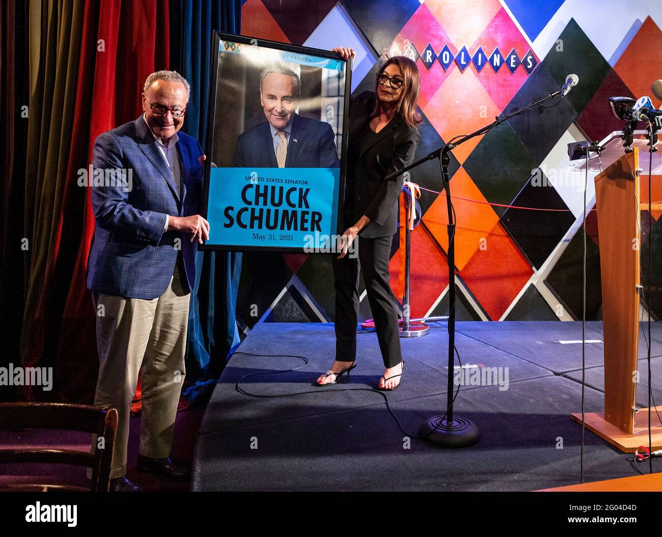 New York, United States. 31st May, 2021. Caroline Hirsch presents U. S. Senator Charles Schumer with poster at Carolines on Broadway comedy club re-opening after pandemic ceremony. Senator Charles Schumer lauded Safe our Stages (SOS) bill passed by Senate to help cultural venues to survive pandemic. He also cracked few jokes saying it is comedy club he does not have a choice but say them. (Photo by Lev Radin/Pacific Press) Credit: Pacific Press Media Production Corp./Alamy Live News Stock Photo