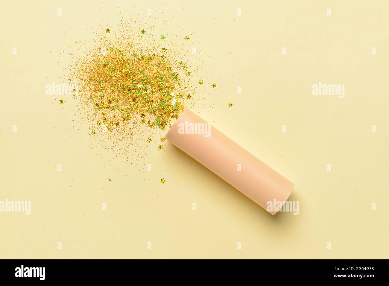 Party popper and confetti on color background Stock Photo