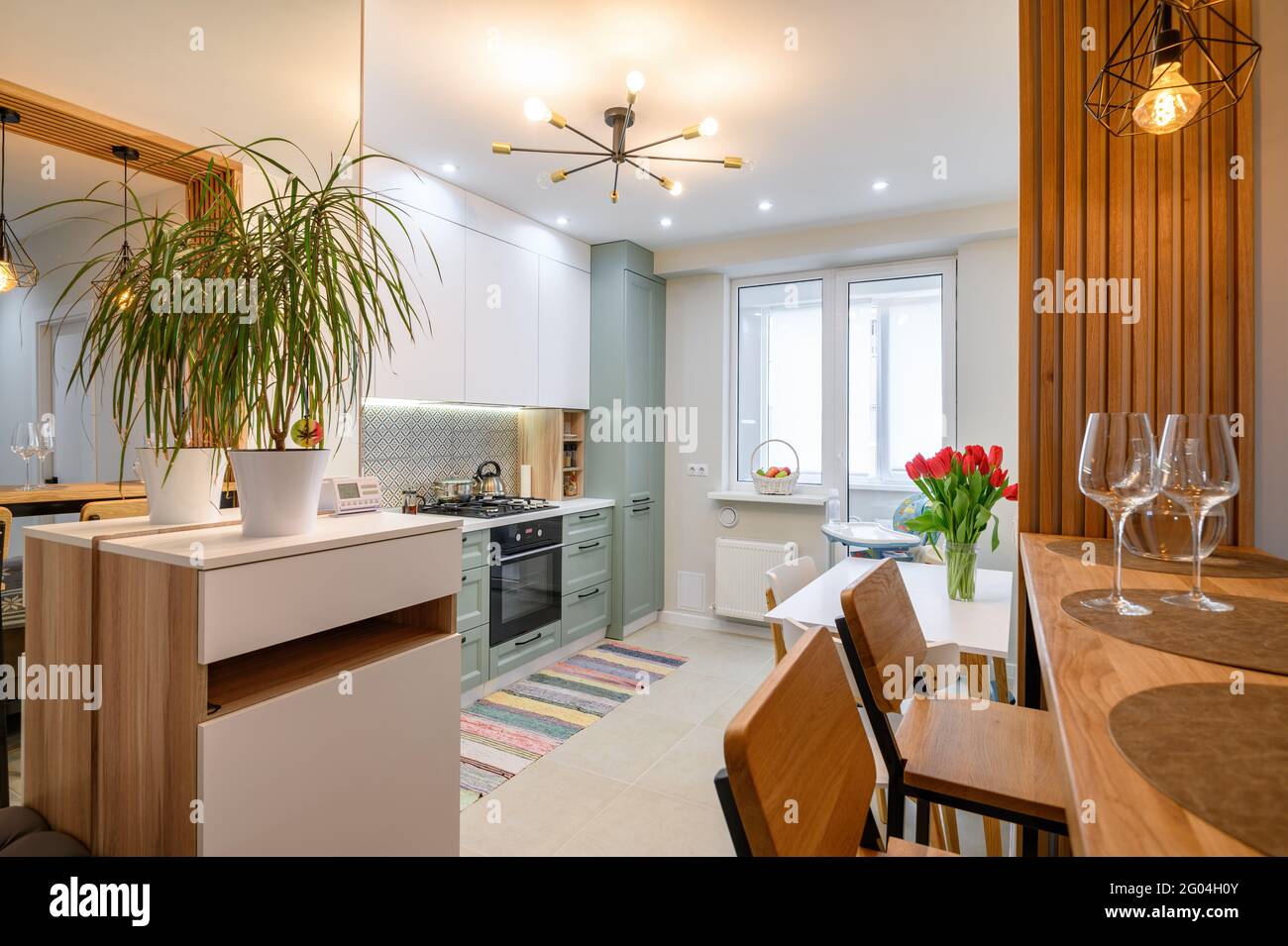 Modern classic white kitchen interior with dining zone Stock Photo - Alamy