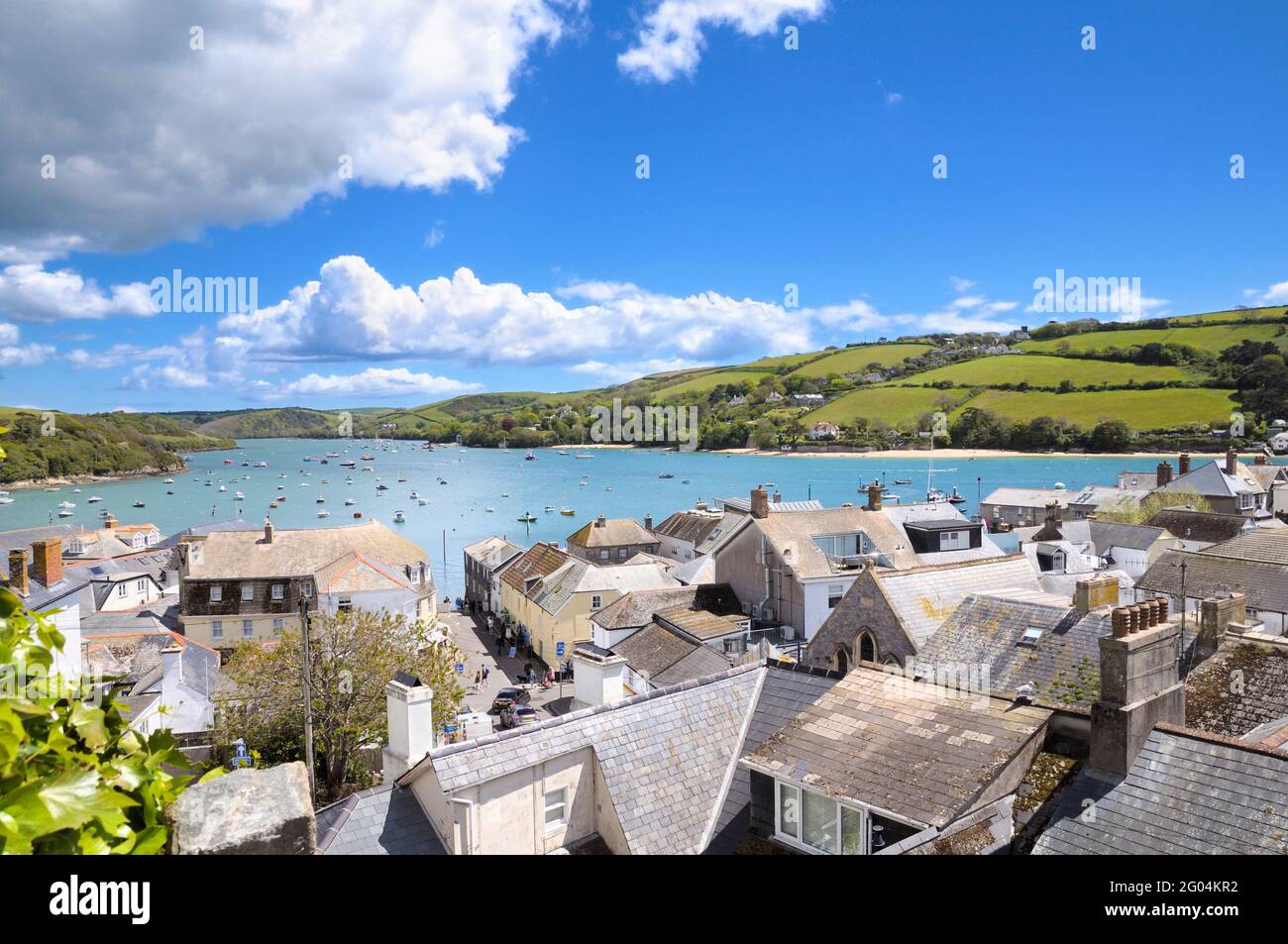 View over the town and rooftops of Salcombe looking across the Kingsbridge Estuary on a bright, clear sunny day. South Hams, South Devon, England, UK Stock Photo