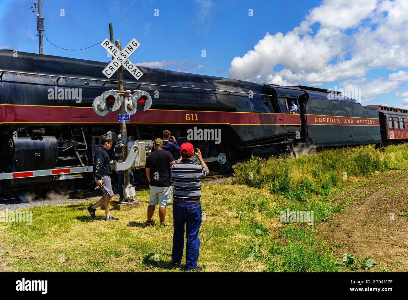 Strasburg, PA, USA - May 31, 2021: Photographers capture images of the Norfolk and Western 611, the sole survivor Class J steam locomotives, on the St Stock Photo