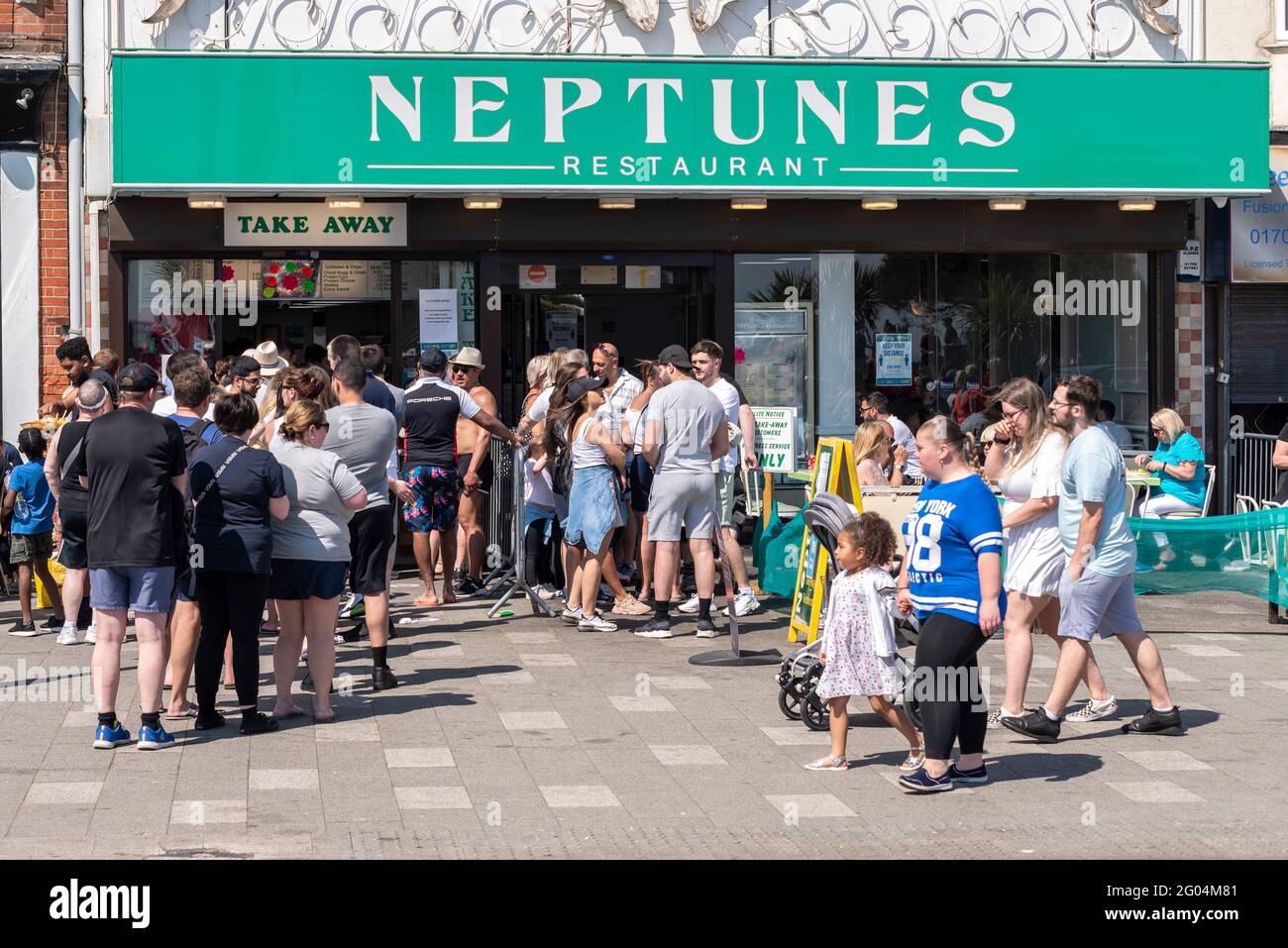Queues outside Neptunes restaurant on late May Bank Holiday Monday in Southend on Sea, Essex, UK, Bright sunny weather. Busy during COVID 19 pandemic Stock Photo