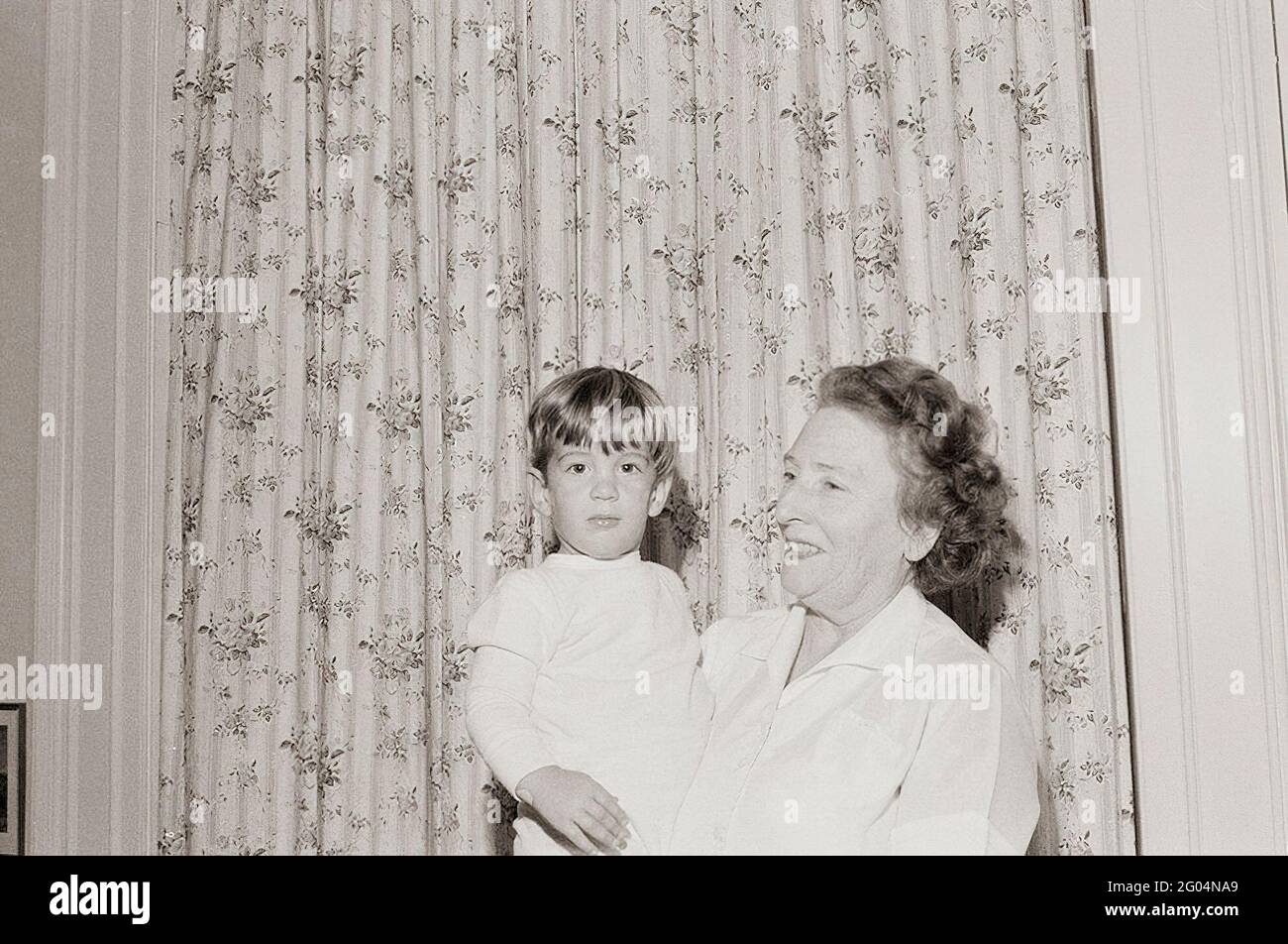 Nanny to the Kennedy children, Maud Shaw, holds John F. Kennedy, Jr