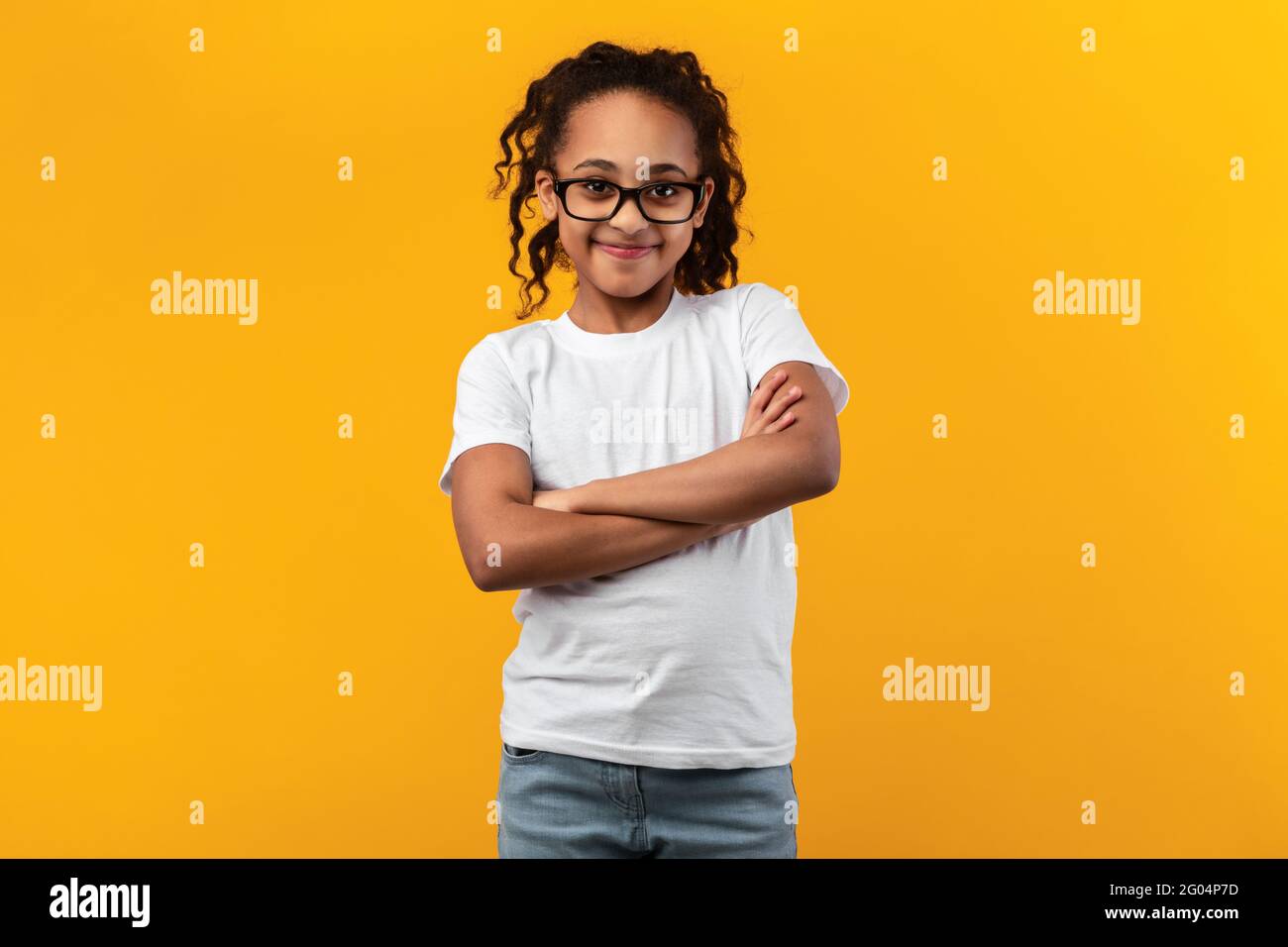 Cute Joyful African American Girl Standing With Folded Arms Stock Photo ...