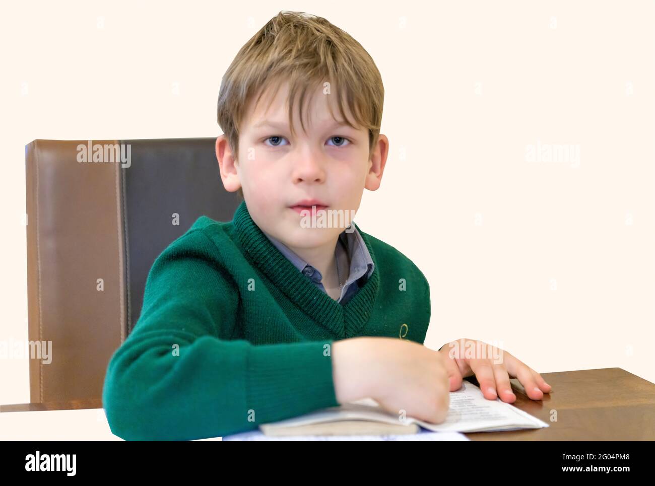 7 years schoolboy doing his school homework Stock Photo