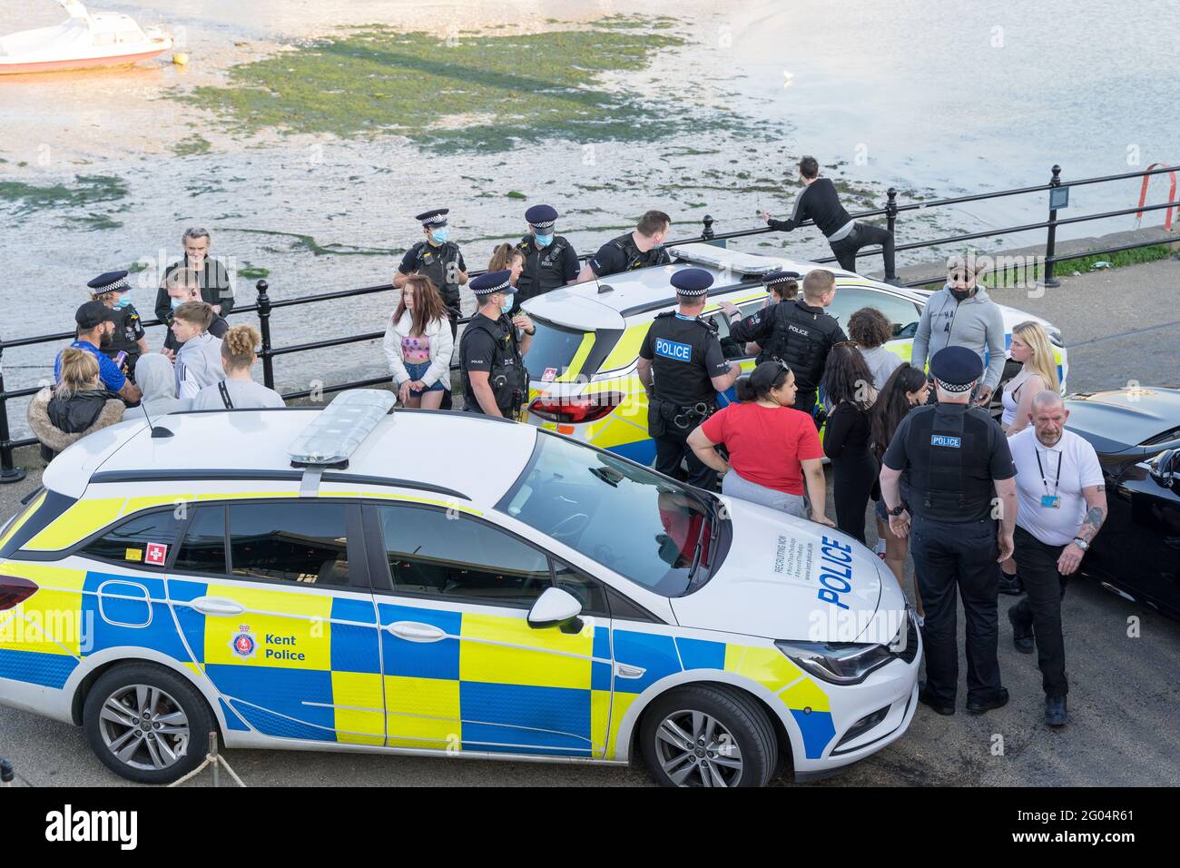bank holiday Monday , Police force talking to party goers outside  Lighthouse bar, Margate after arresting a man into marked police car, England Stock Photo