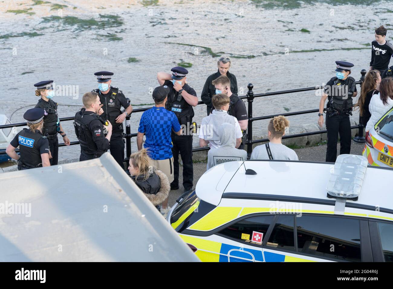 bank holiday Monday , Polece force talking to party goers outside  Lighthouse bar, Margate after arresting a man into marked police car, England Stock Photo