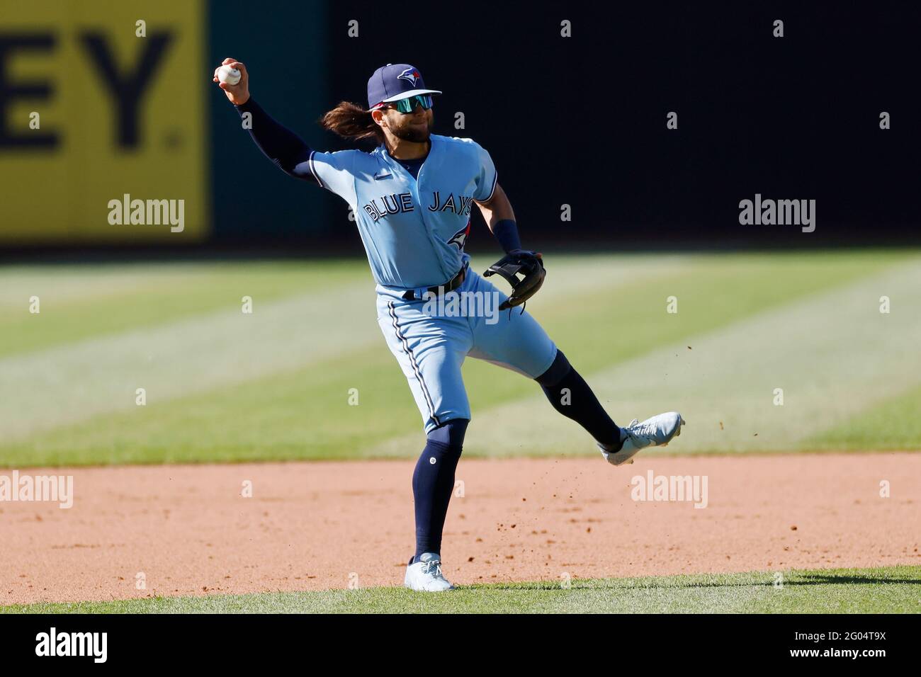 Bo Bichette of the Toronto Blue Jays flicks his hair back after