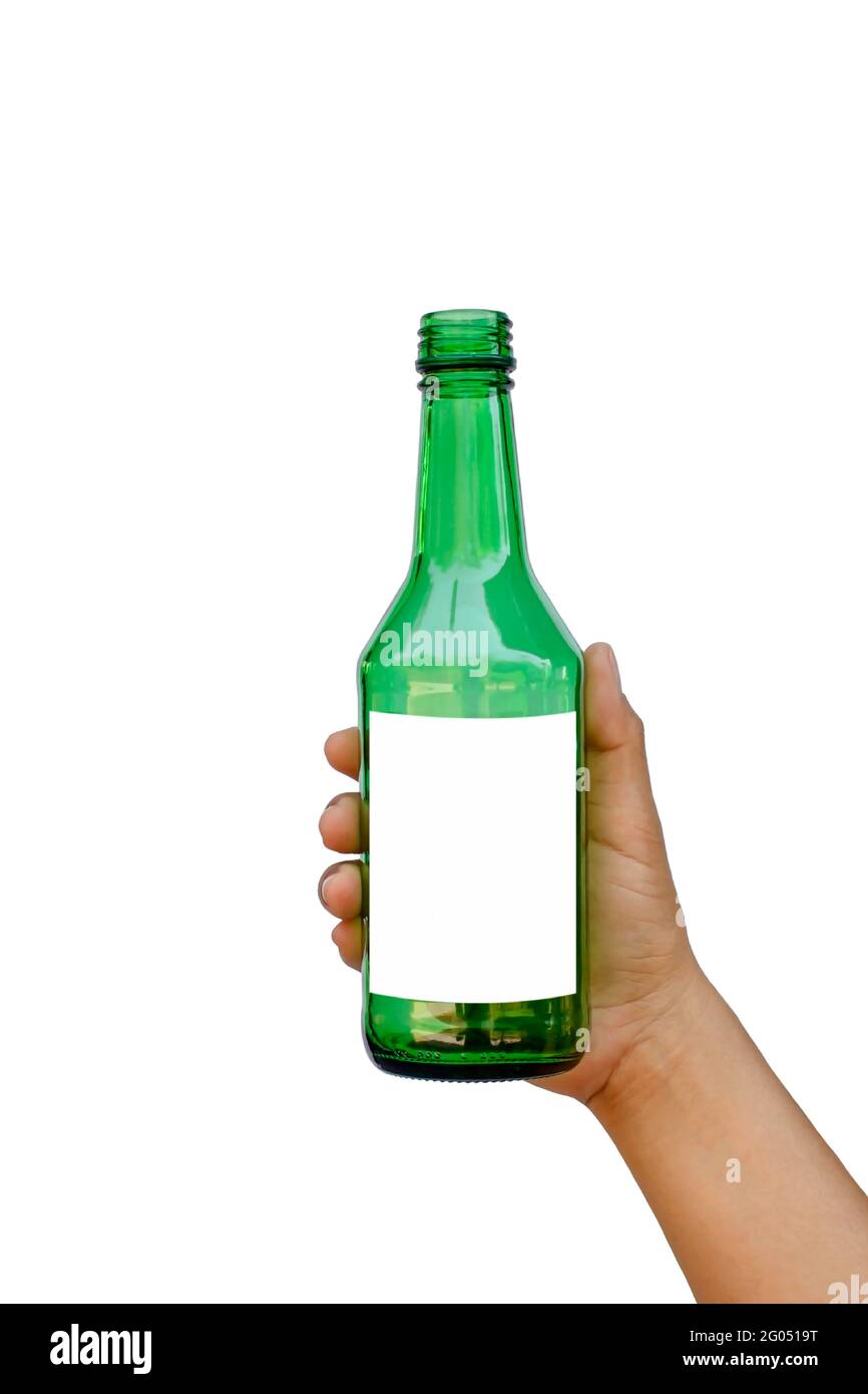 Hand holding an empty green glass bottle with a text space isolated on a white background with the clipping path. Stock Photo