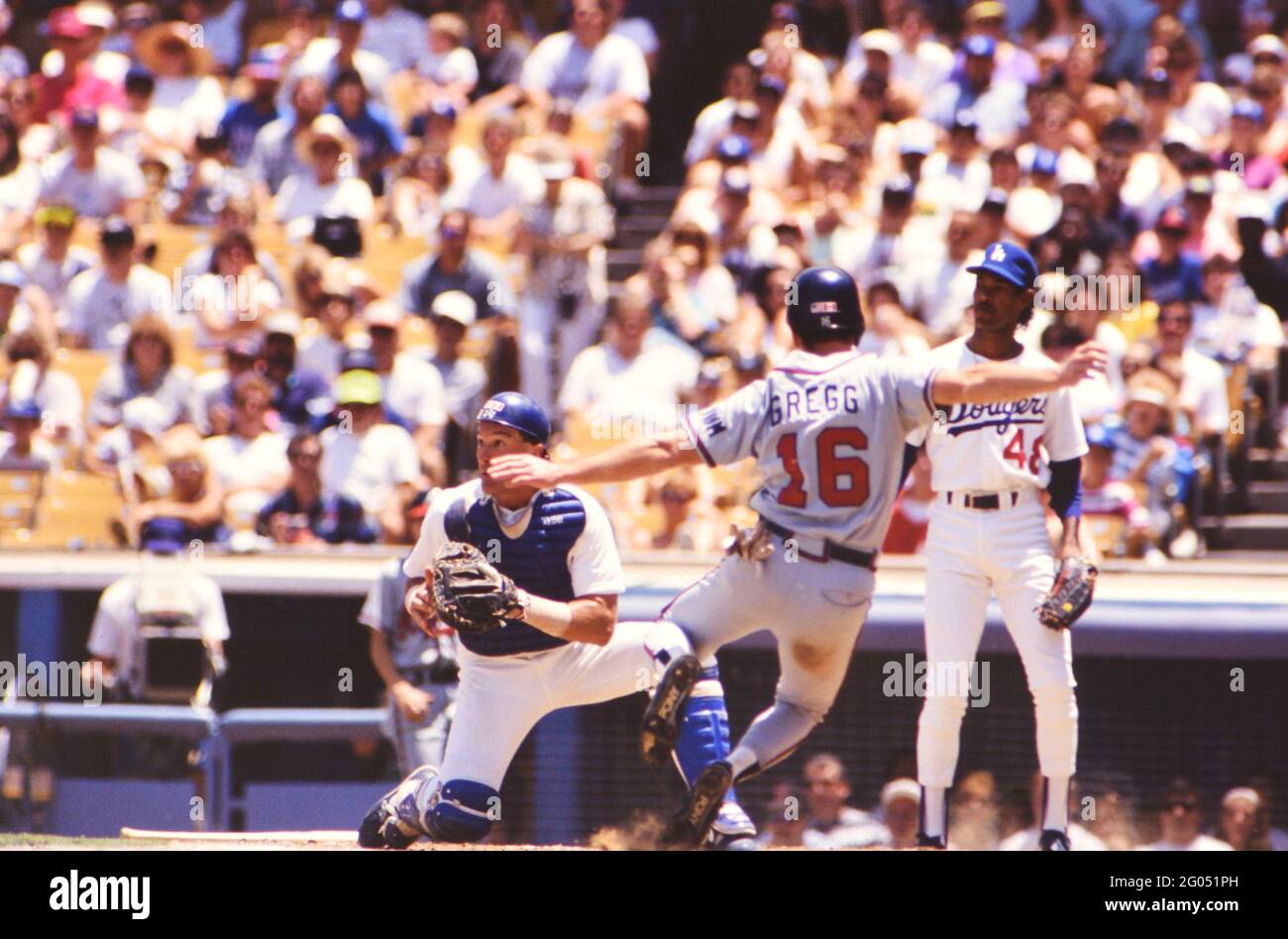 Los Angeles baseball player Brett Butler watches as teammates give high  fives at home plate -- Please credit photographer Kirk Schlea Stock Photo -  Alamy