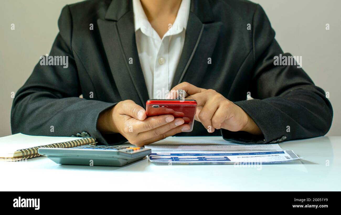 Asian woman paying by credit card online while ordering online at home, transaction idea using mobile banking application. Stock Photo