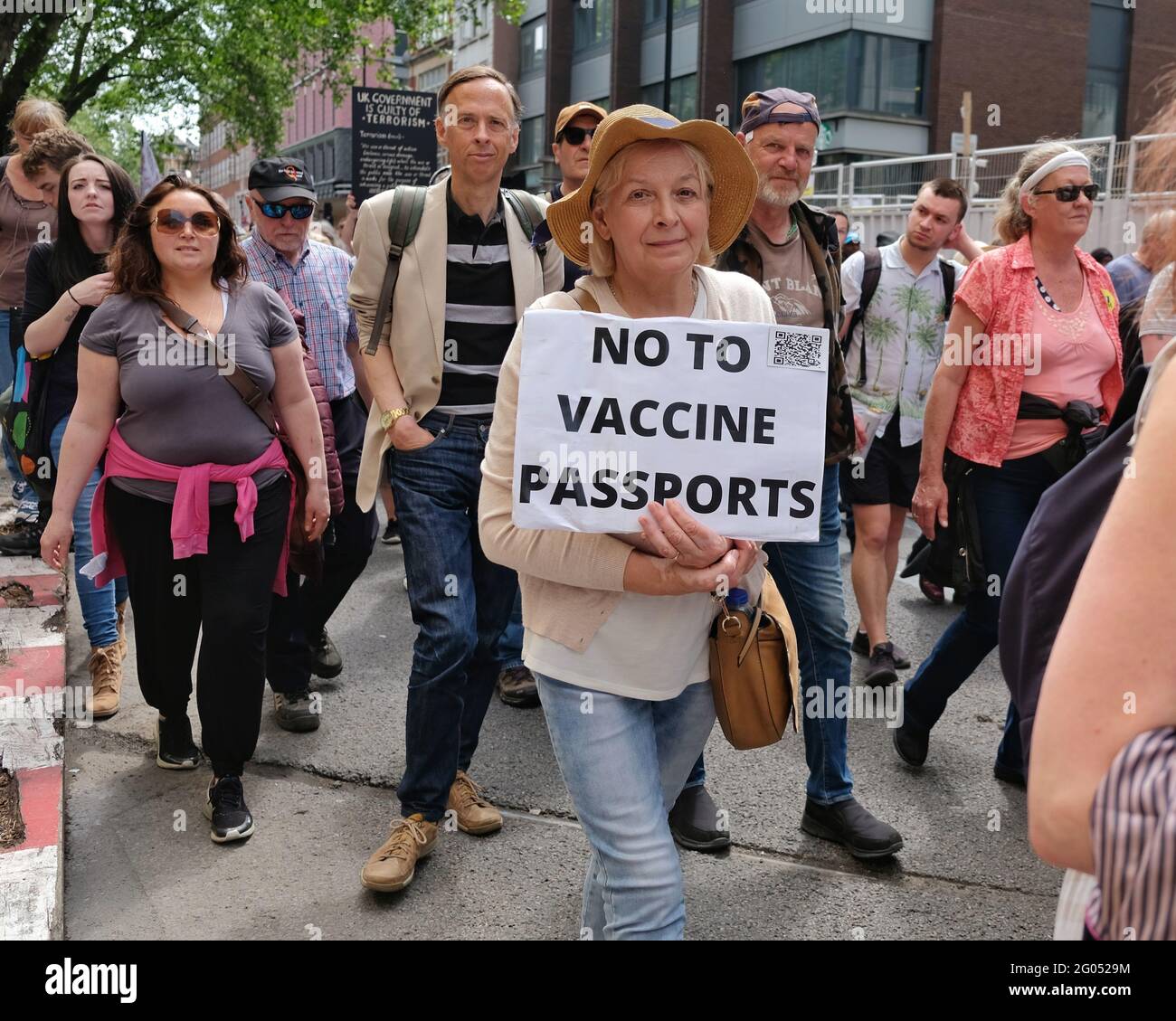 London, UK. 29/05/21. An anti-vaccine passport protester marches with a demonstration to denounce Covid government imposed restrictions. Stock Photo