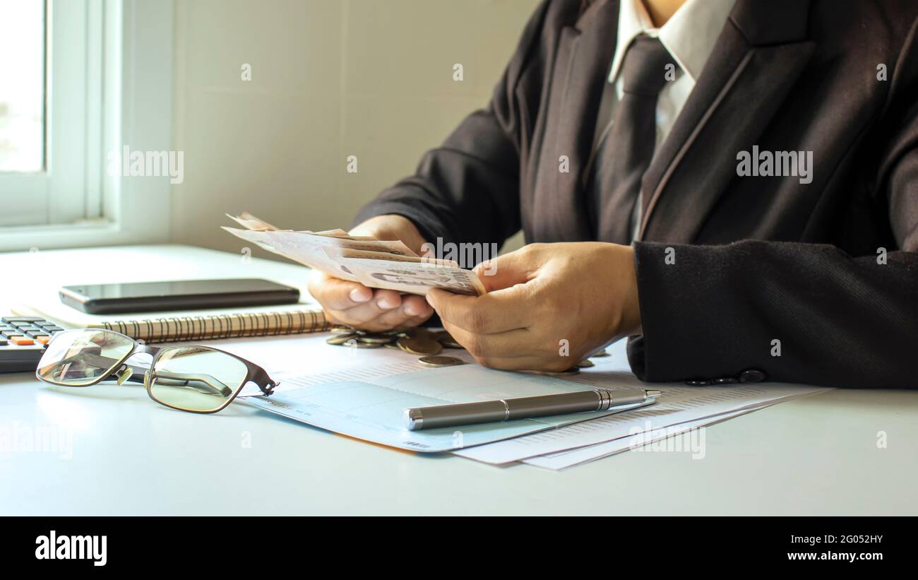Business people counting money to verify business accounts and income concepts of financial management and financing Stock Photo